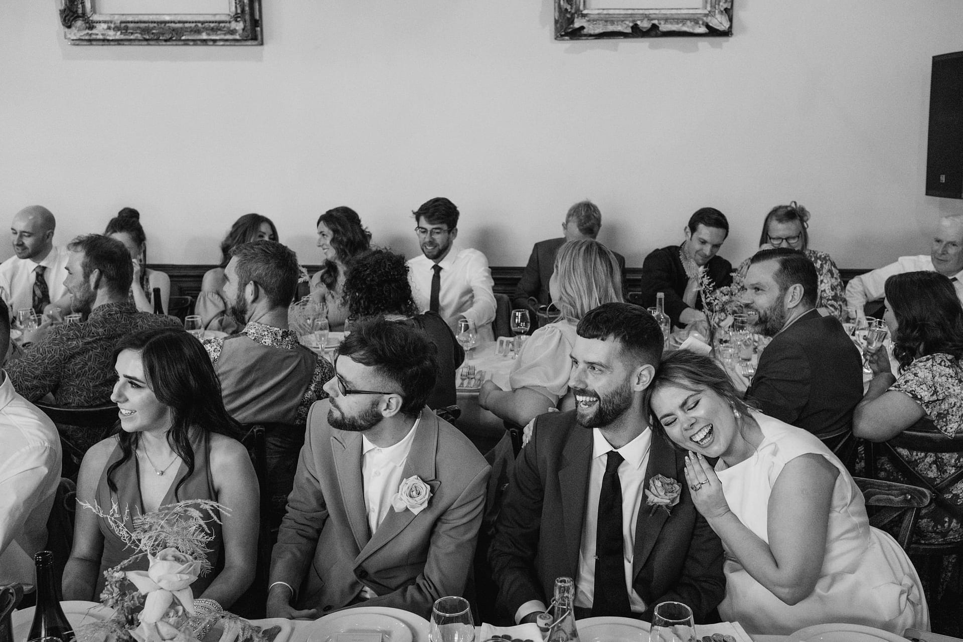Wedding guests laughing and enjoying the reception.