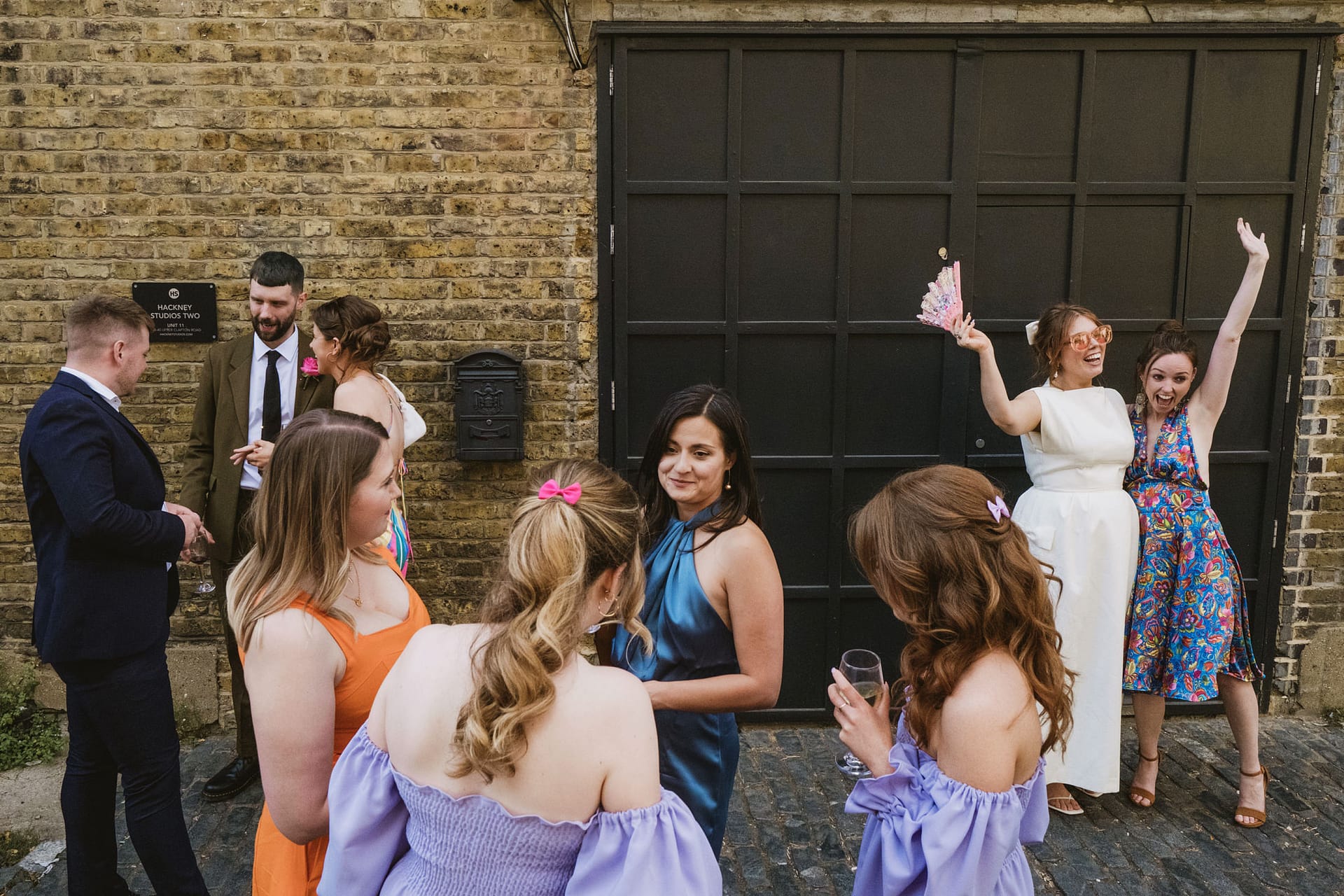 People socialising outside dressed in colourful clothing