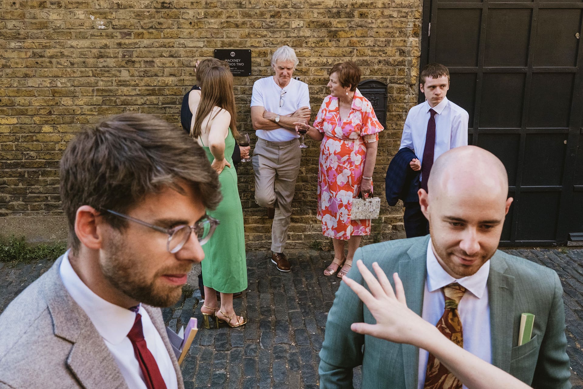 People socialising outdoors in formal attire