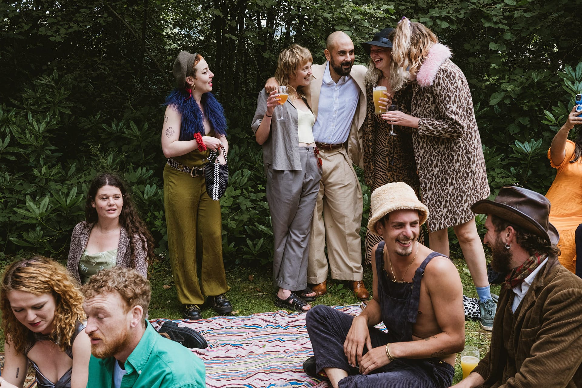 Group of friends enjoying drinks in a park.