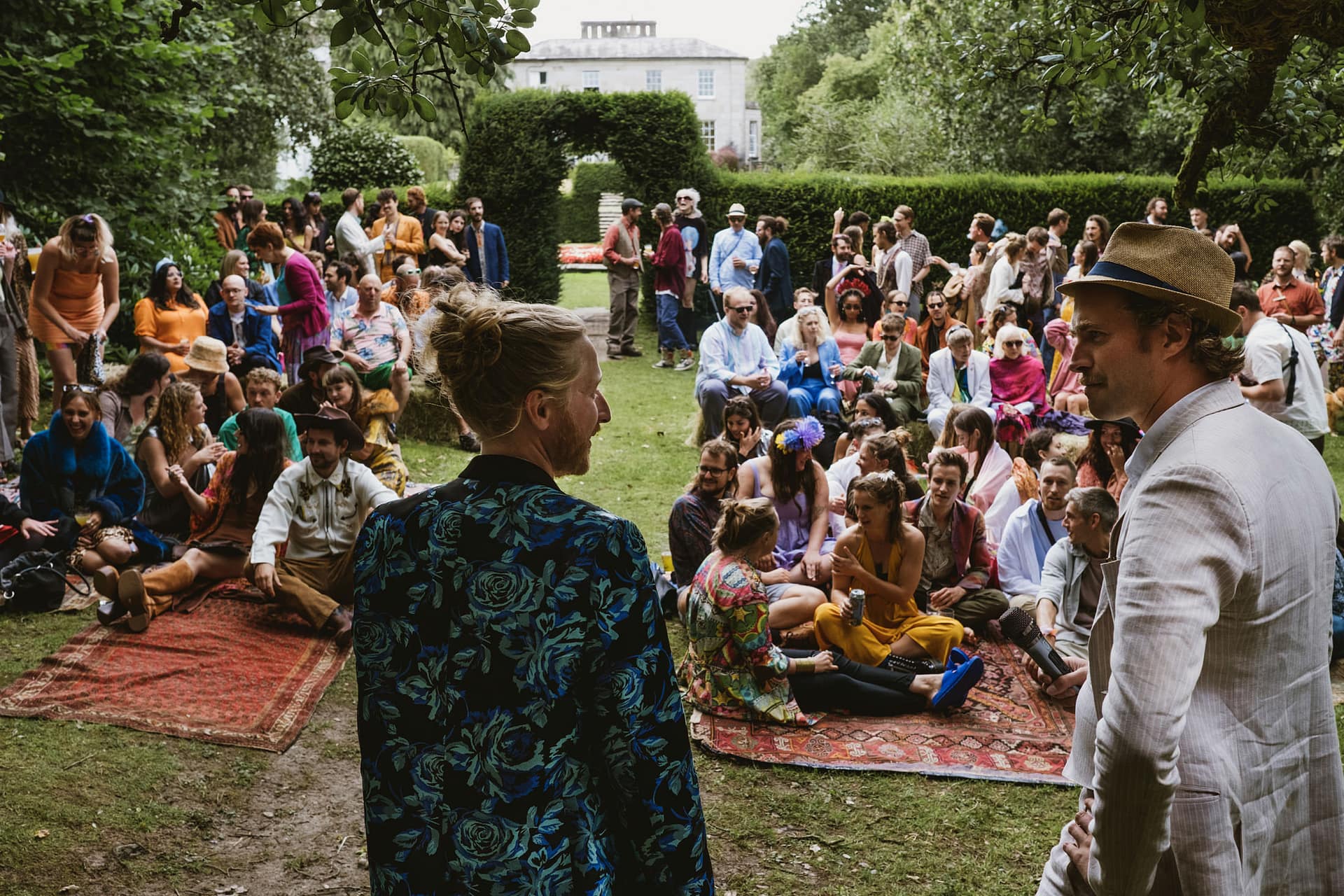 Group of people gathered outdoors, two in foreground.