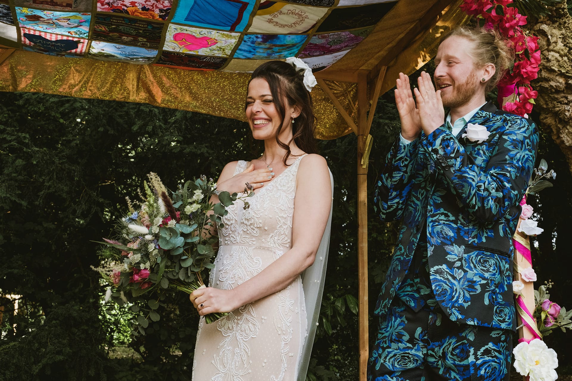 Bride and groom at colourful outdoor wedding.
