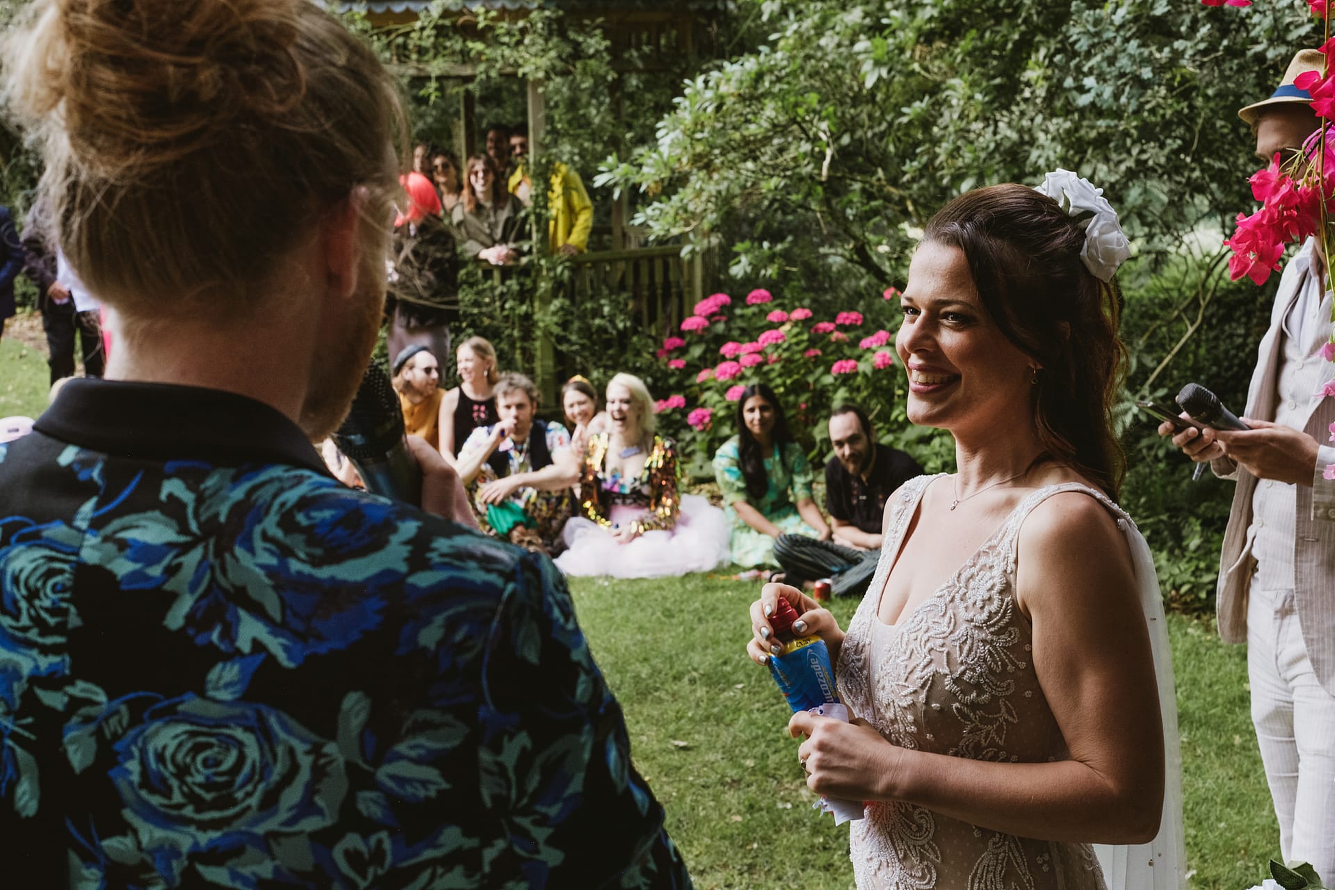 Bride smiling at outdoor wedding ceremony.