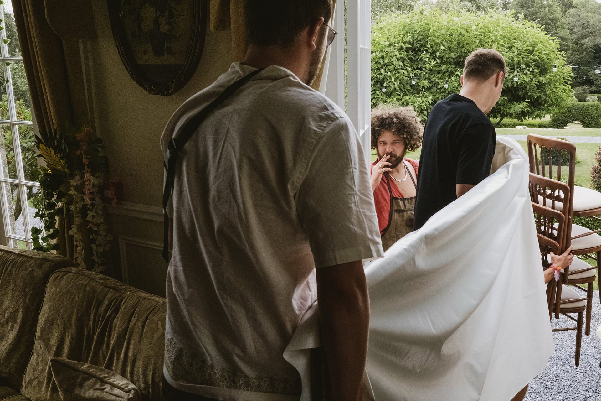 Men moving furniture into a house