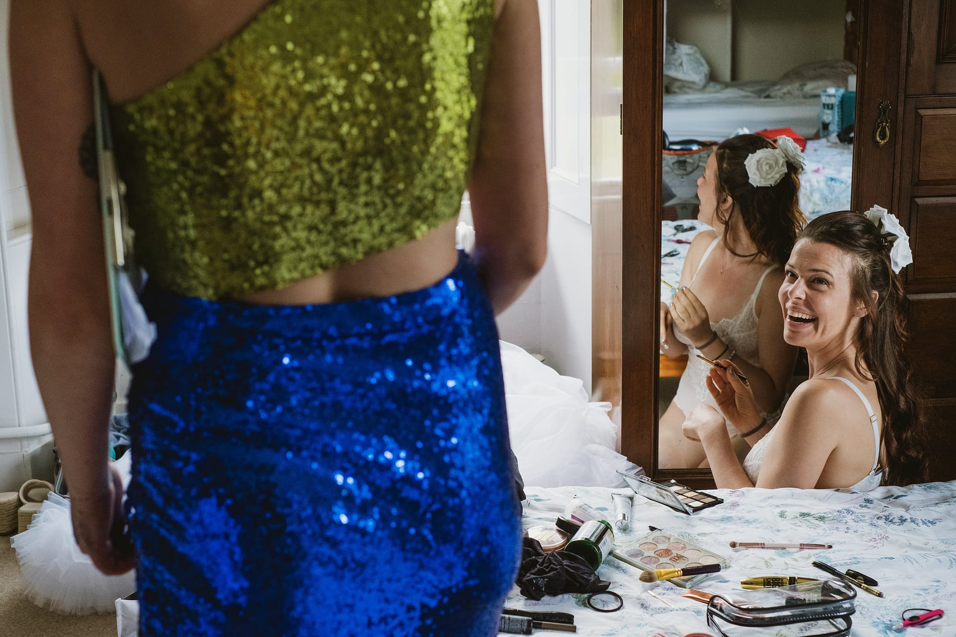 Bride laughing, preparing for the wedding in bedroom