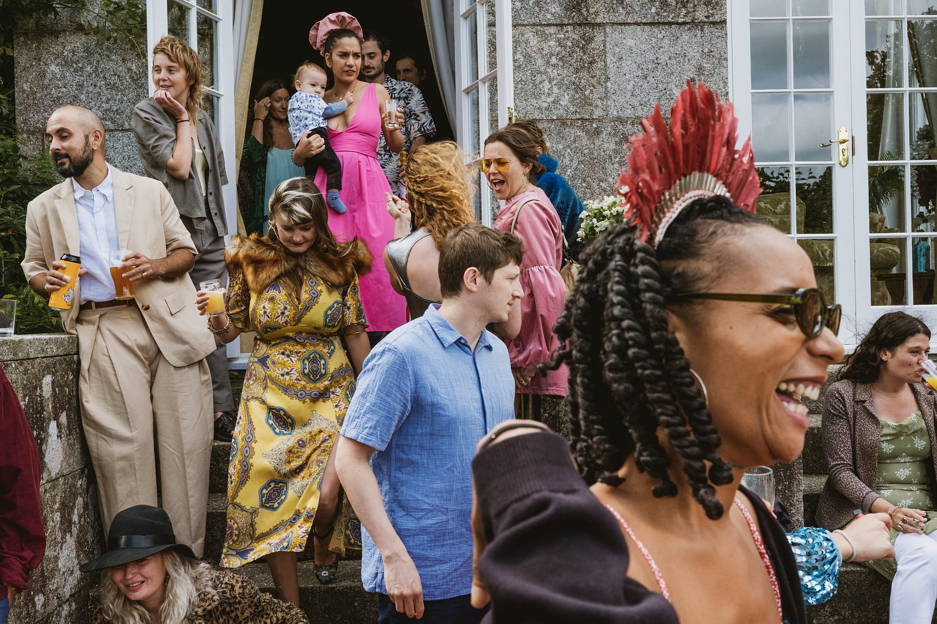 People in colourful clothes enjoying a festive gathering.