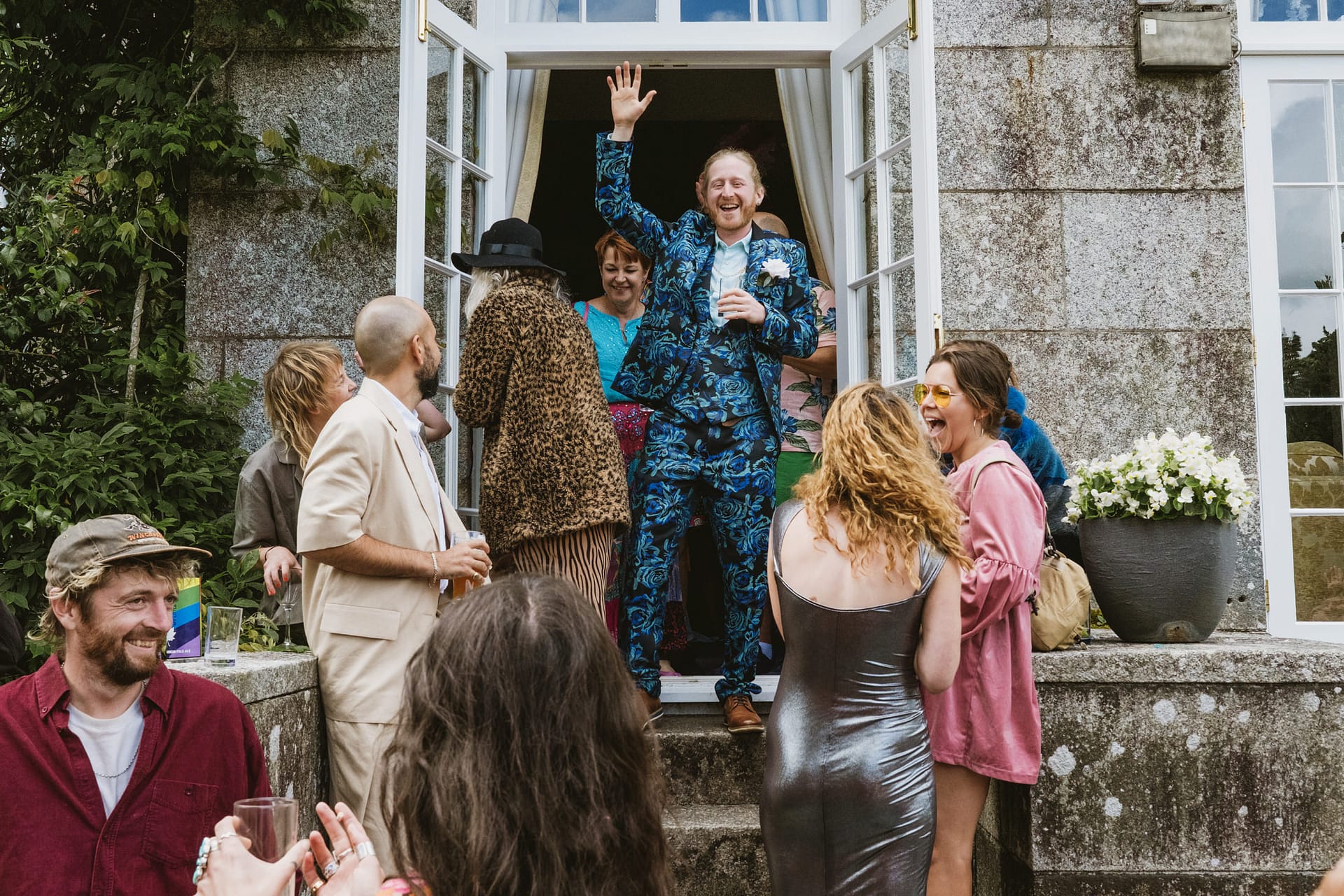 Group of people celebrating outside a house.