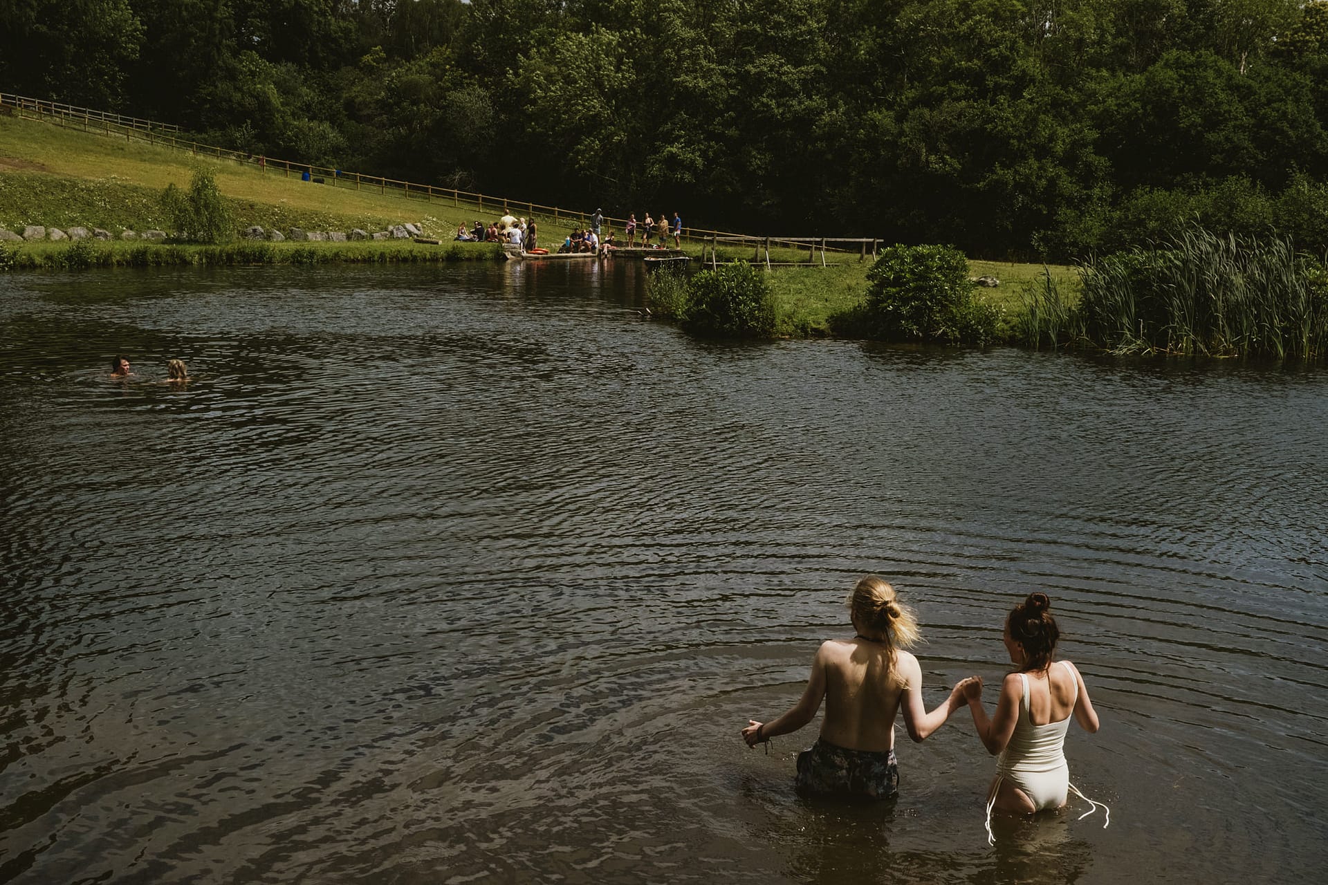 People swimming and relaxing by the lake