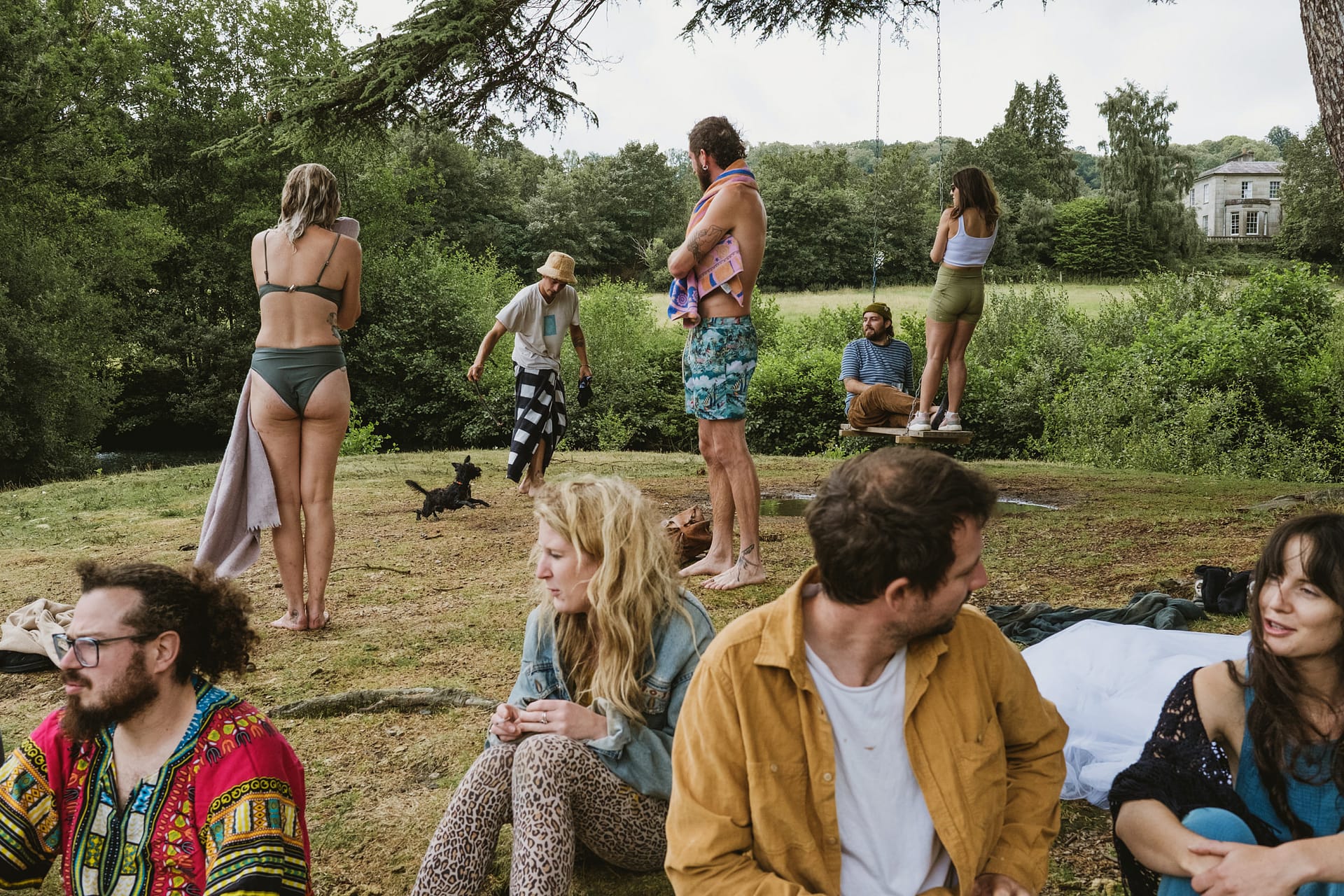Group enjoying outdoors with trees and Colehayes Park in the background.