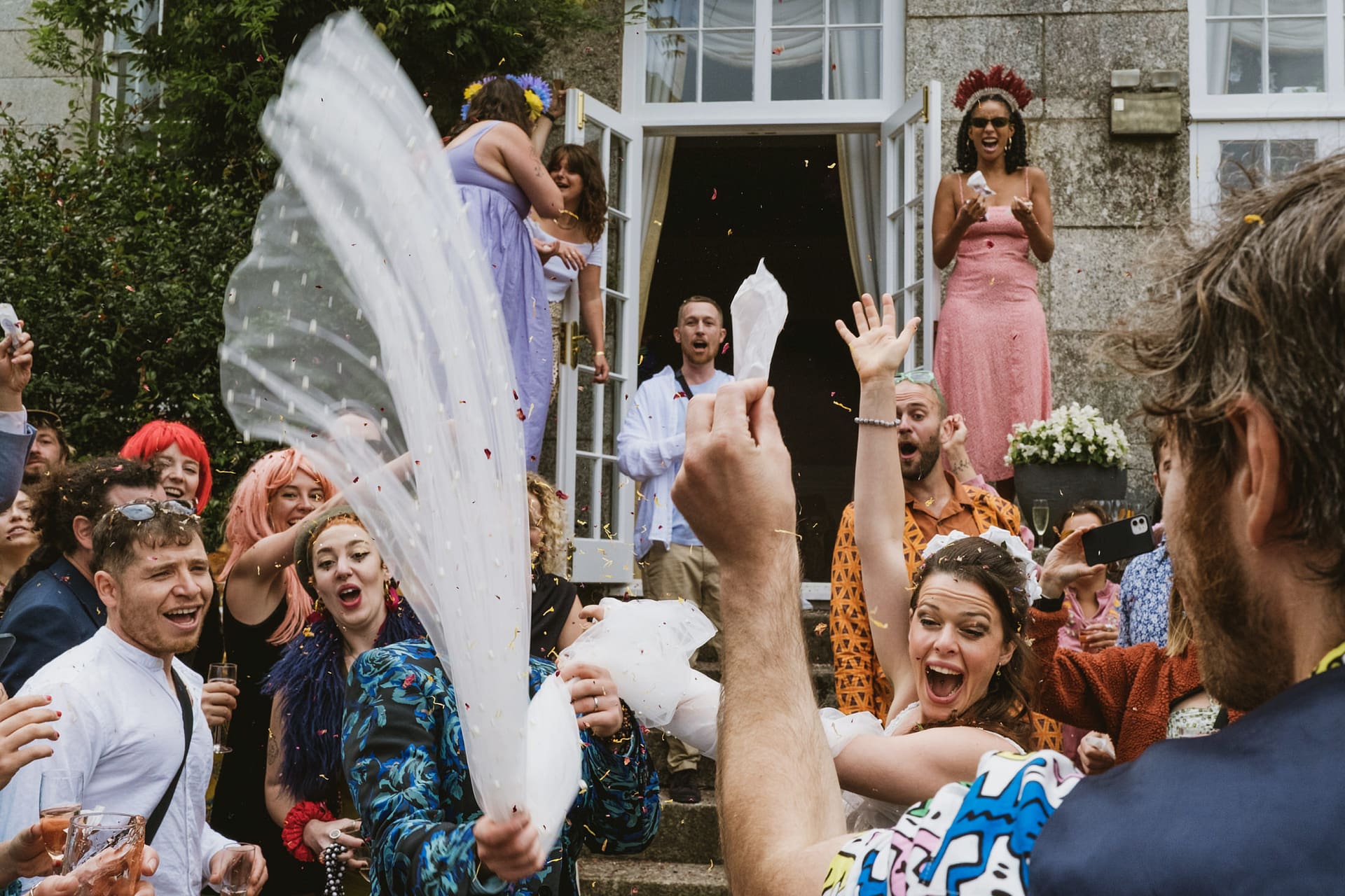 Joyful outdoor celebration with confetti and vibrant outfits.