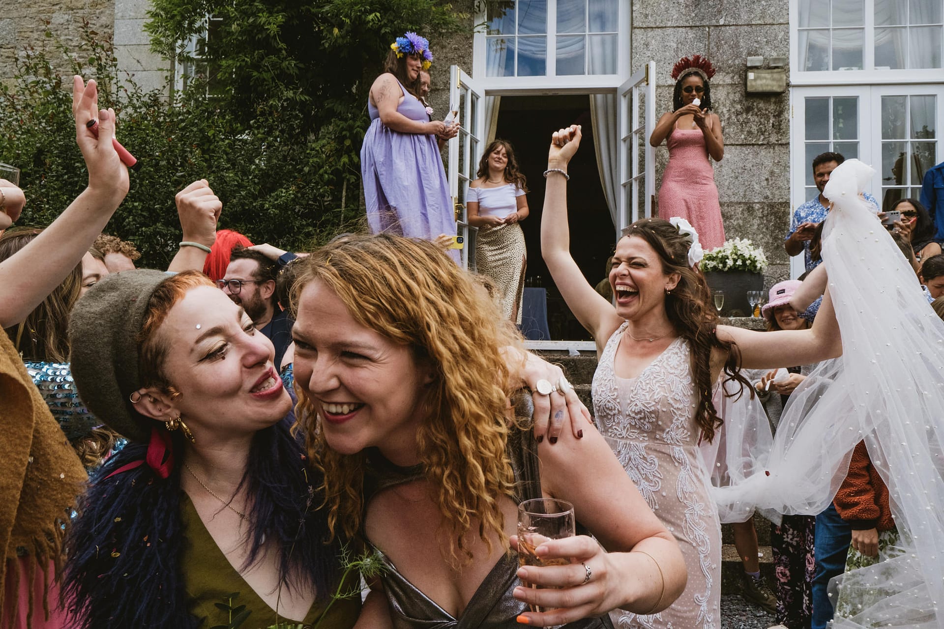 Group celebrating at an outdoor wedding reception