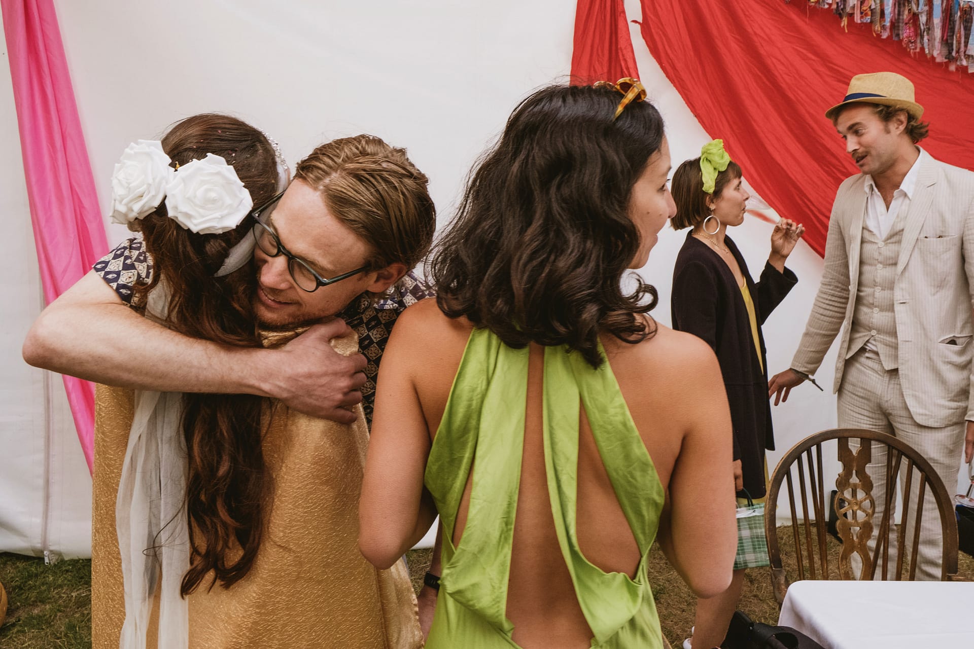 People embracing and conversing at an event.