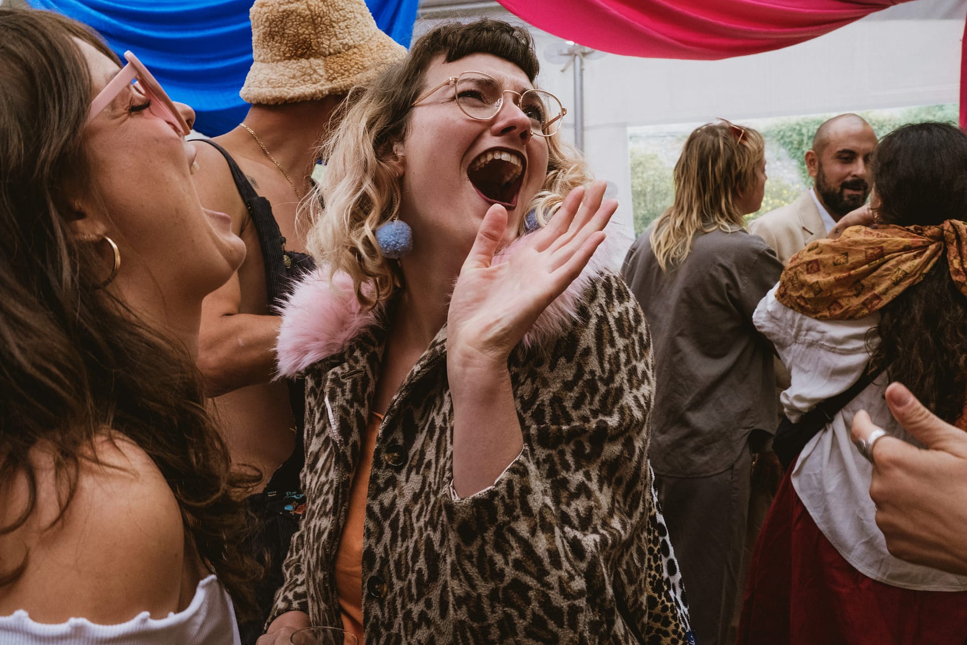 People laughing at a lively party.