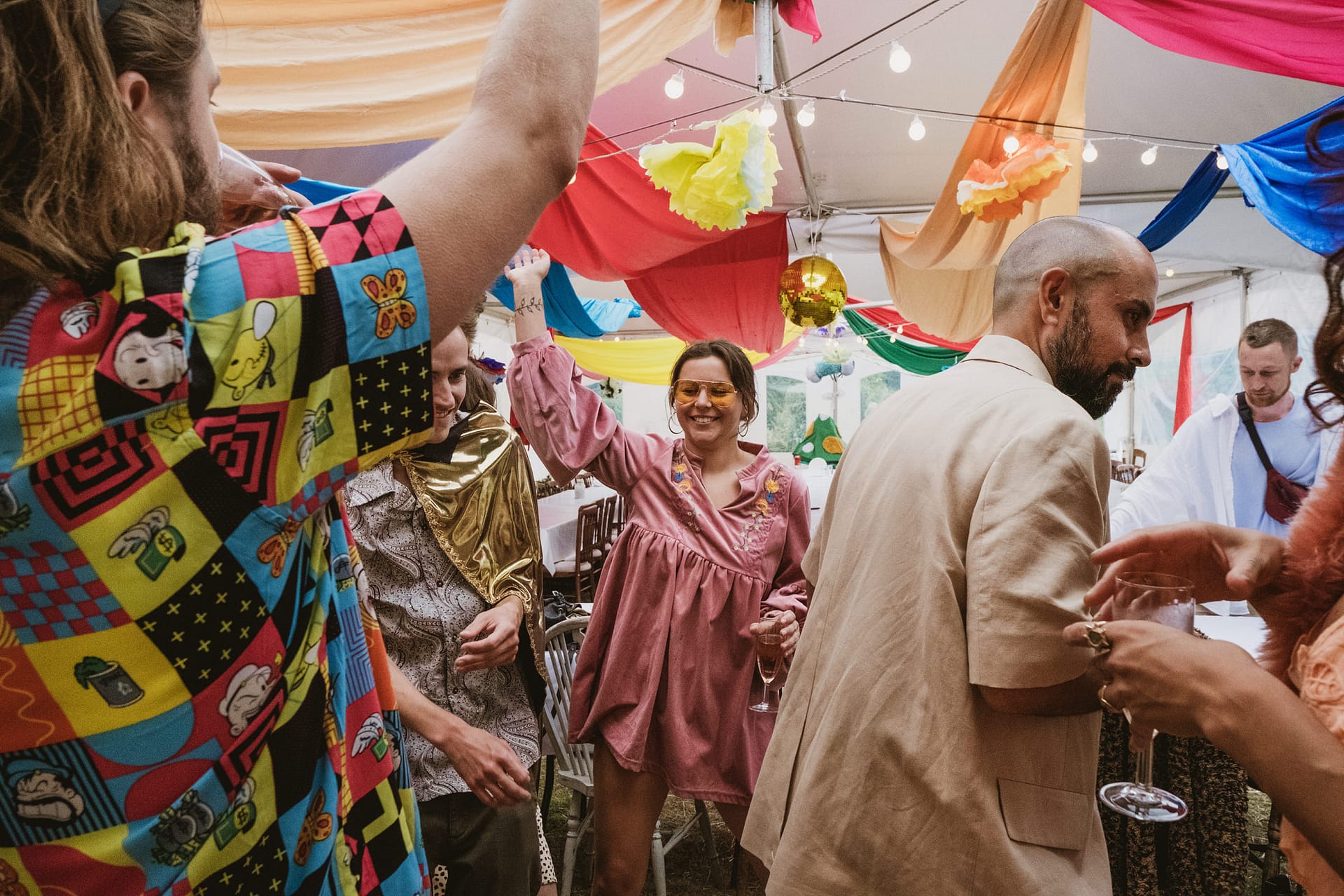 People celebrating at a colourful indoor party.