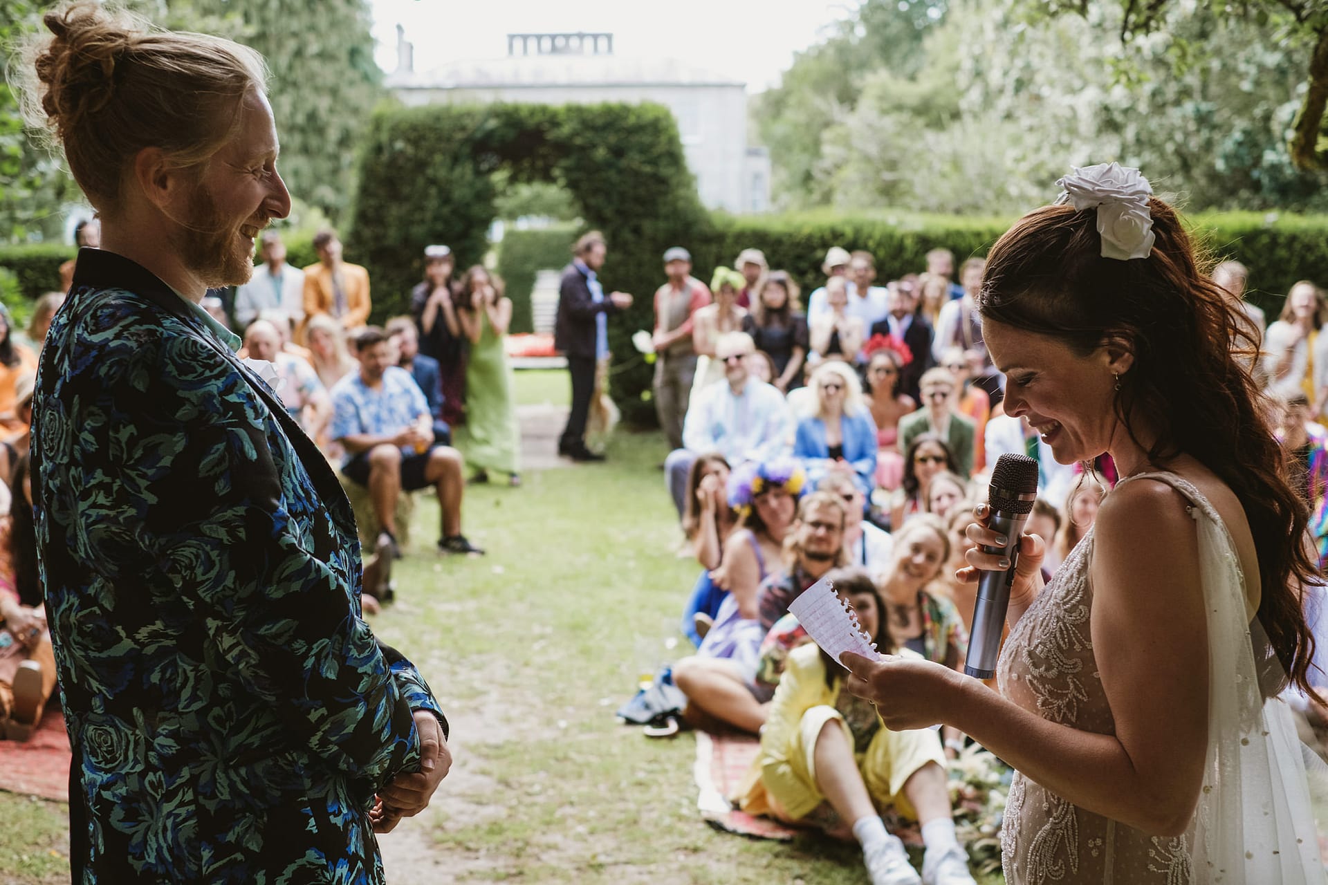 Outdoor wedding celebration with happy couple and guests