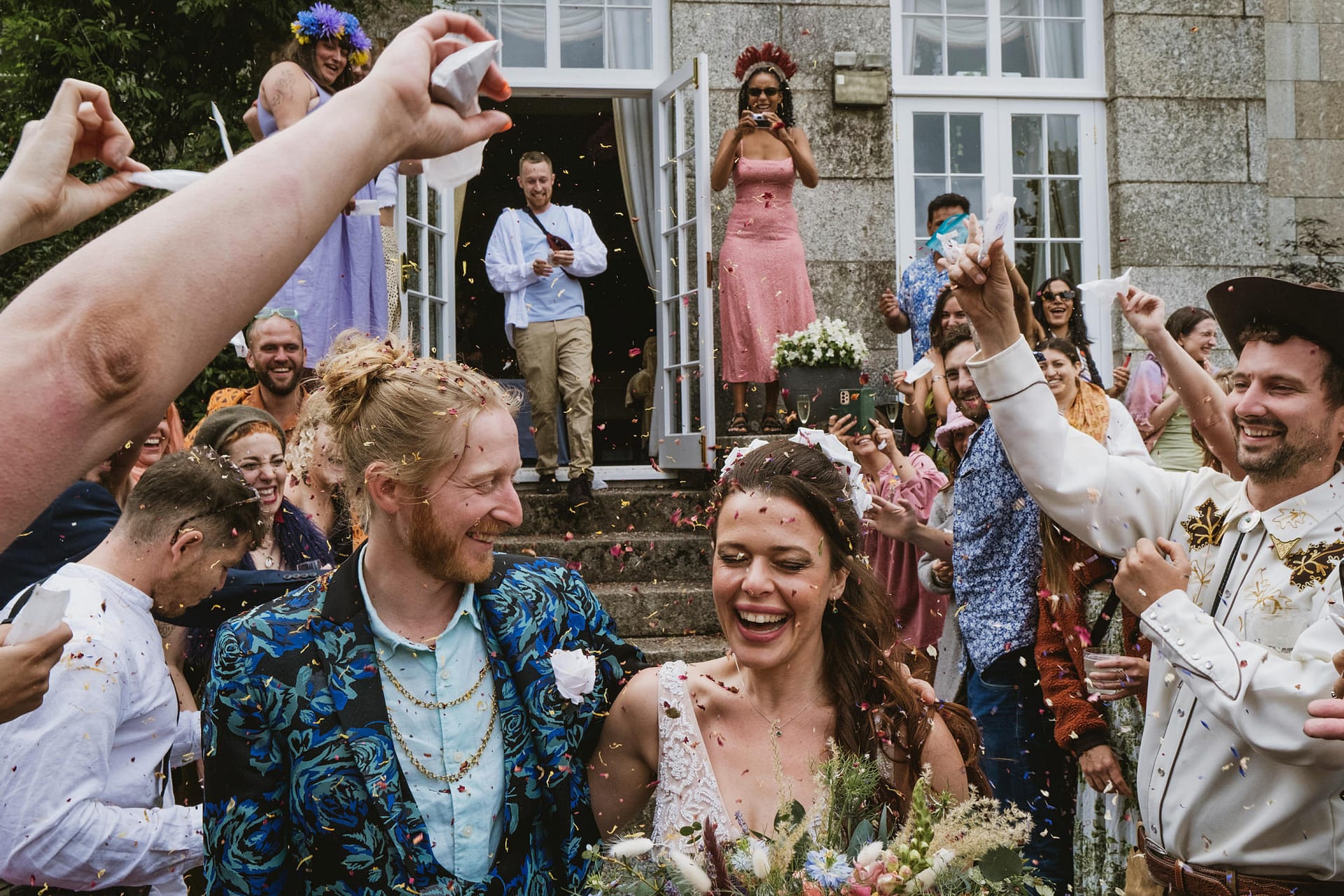 Bride and groom celebrate with guests at wedding.