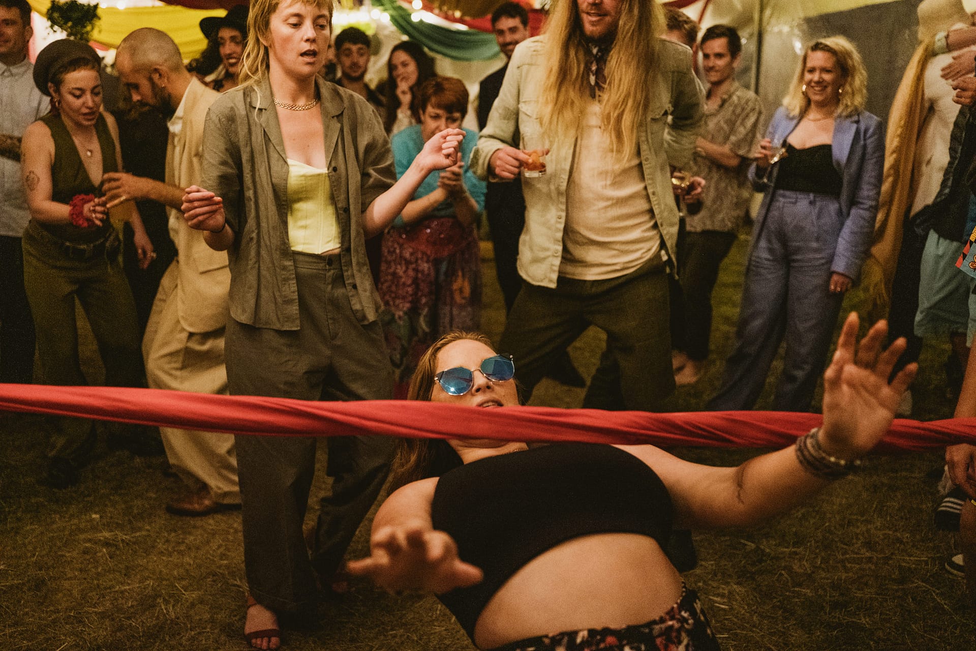 People dancing and playing limbo at a party.