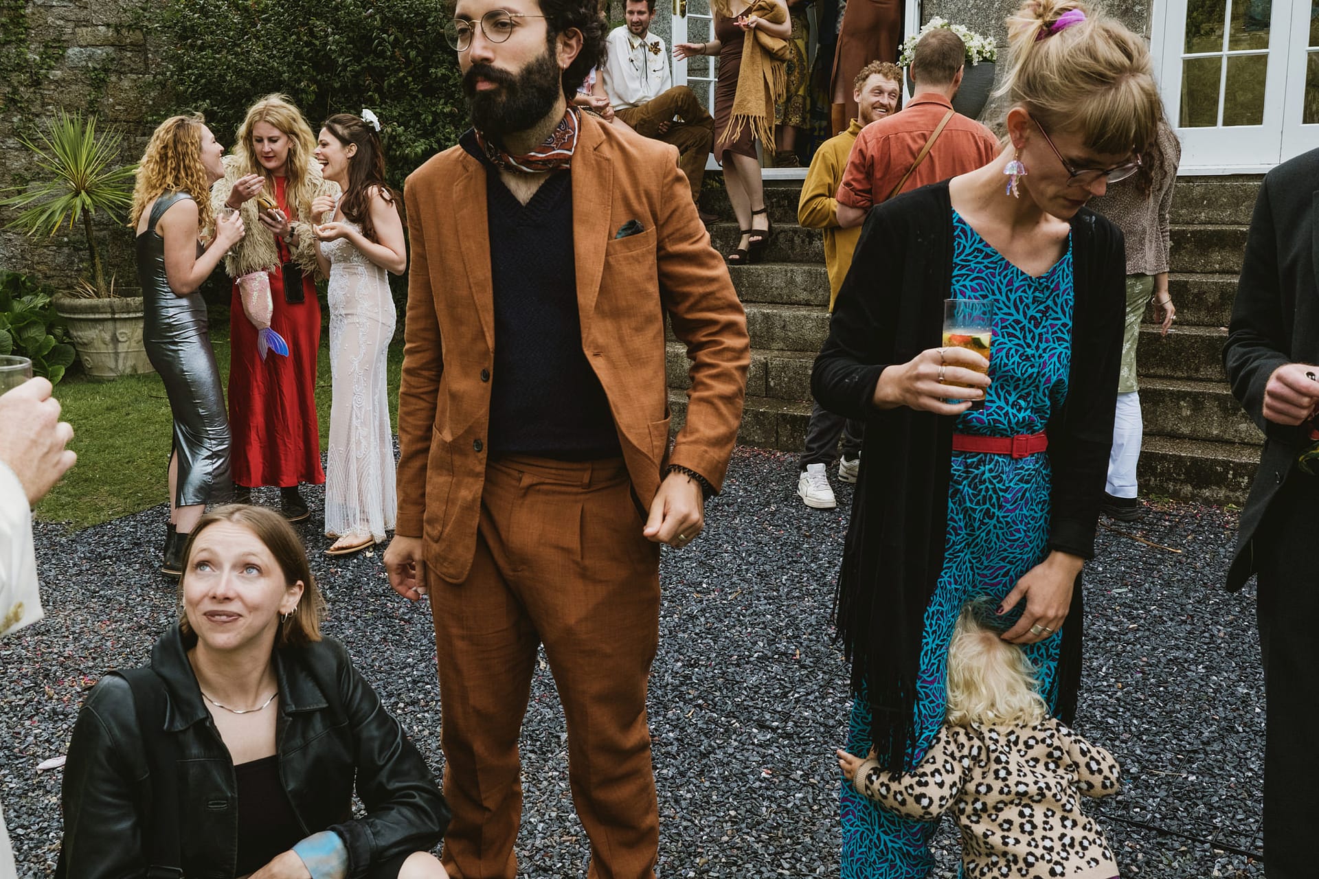 Guests at outdoor party, socialising and drinking