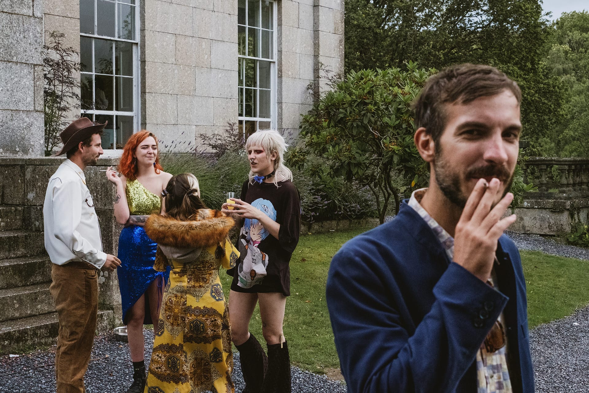 Group of friends socialising outdoors near building.