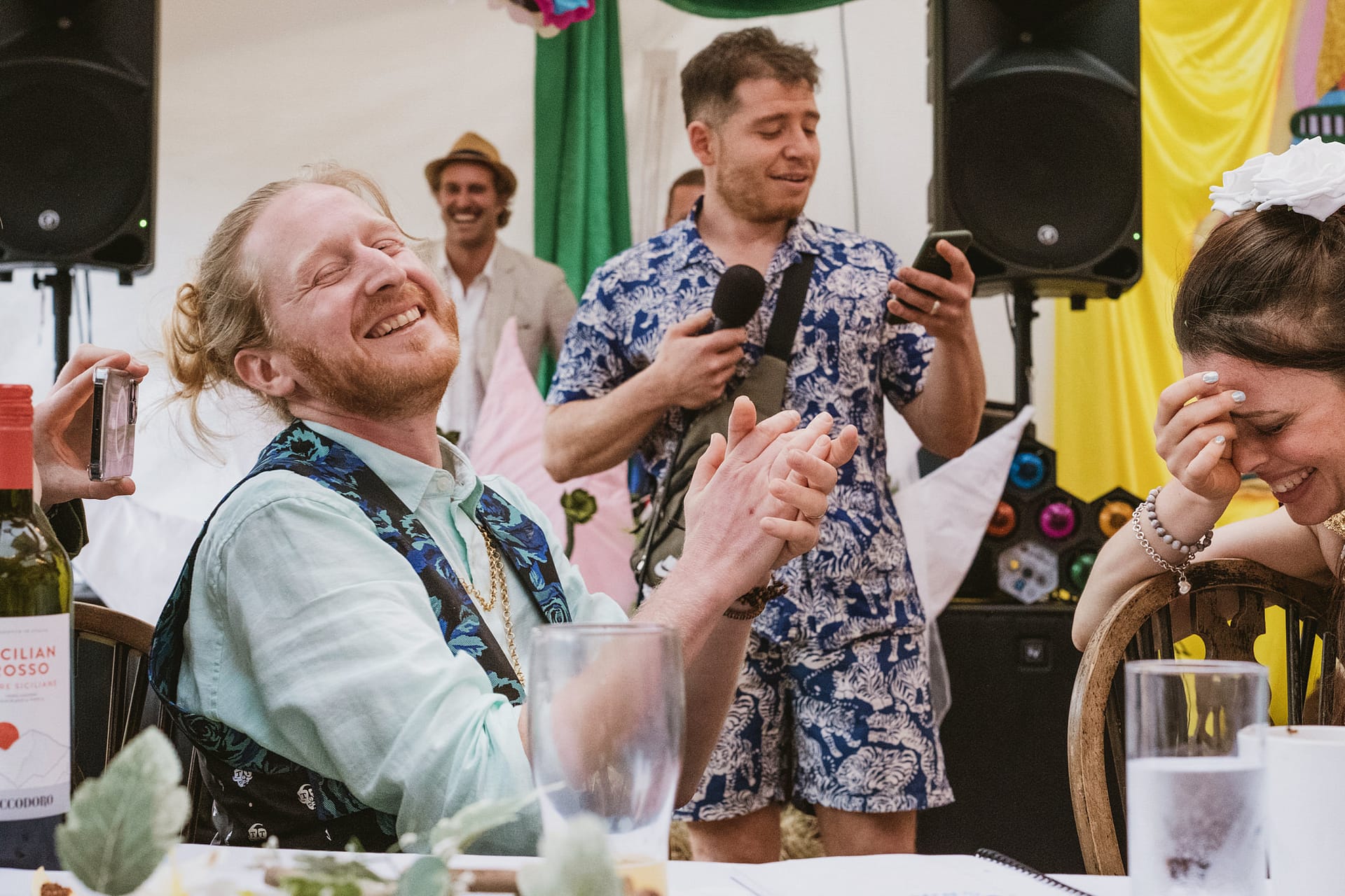 Guests laughing at a lively party gathering.