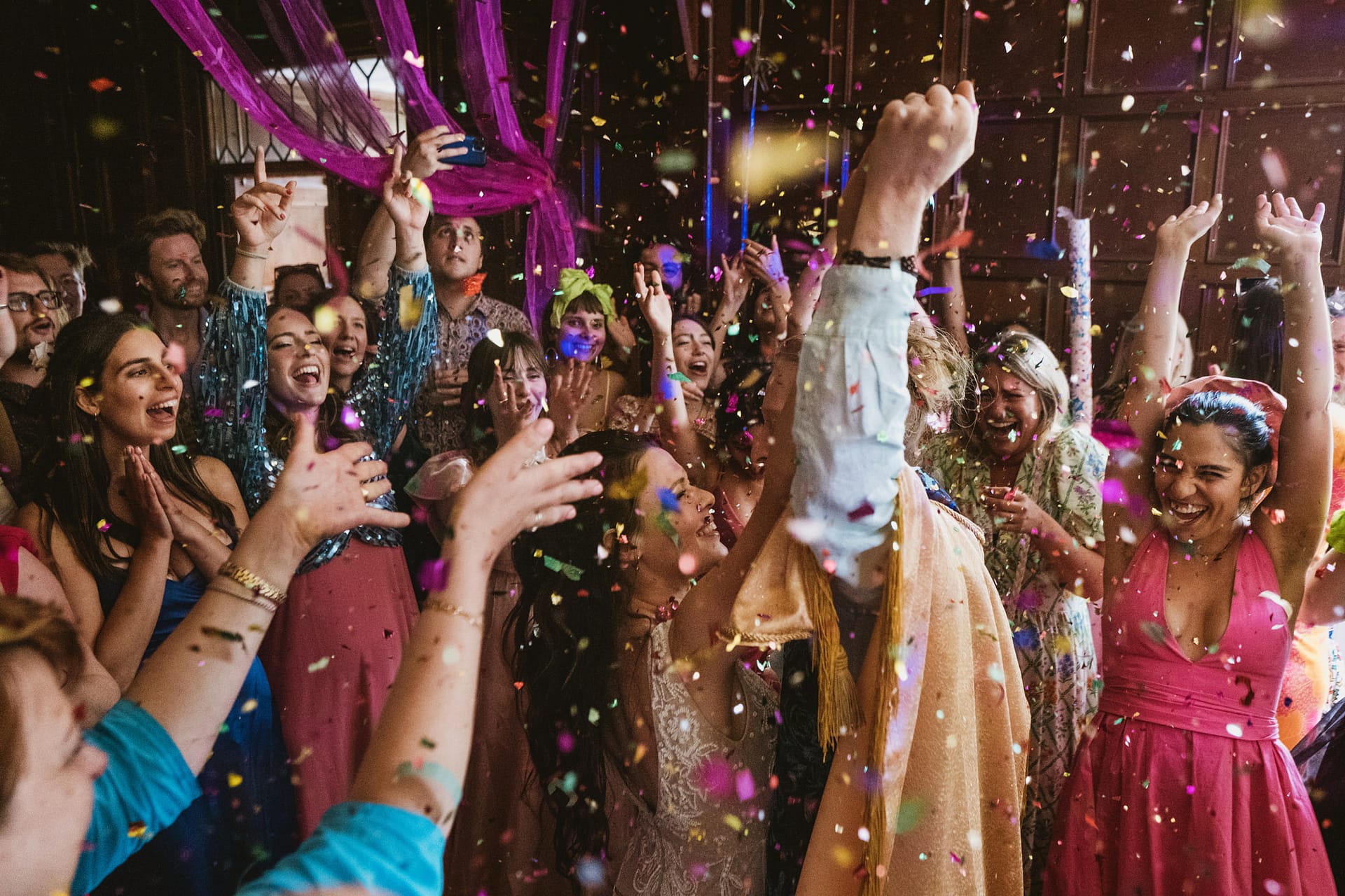 People celebrating with confetti at a party.