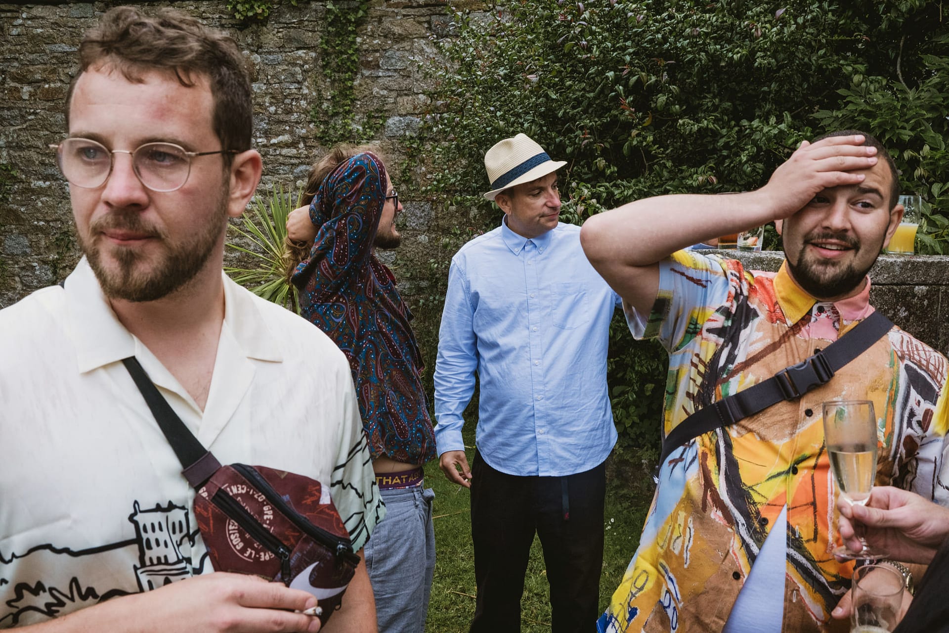 Group of men outdoors, wearing casual clothes.