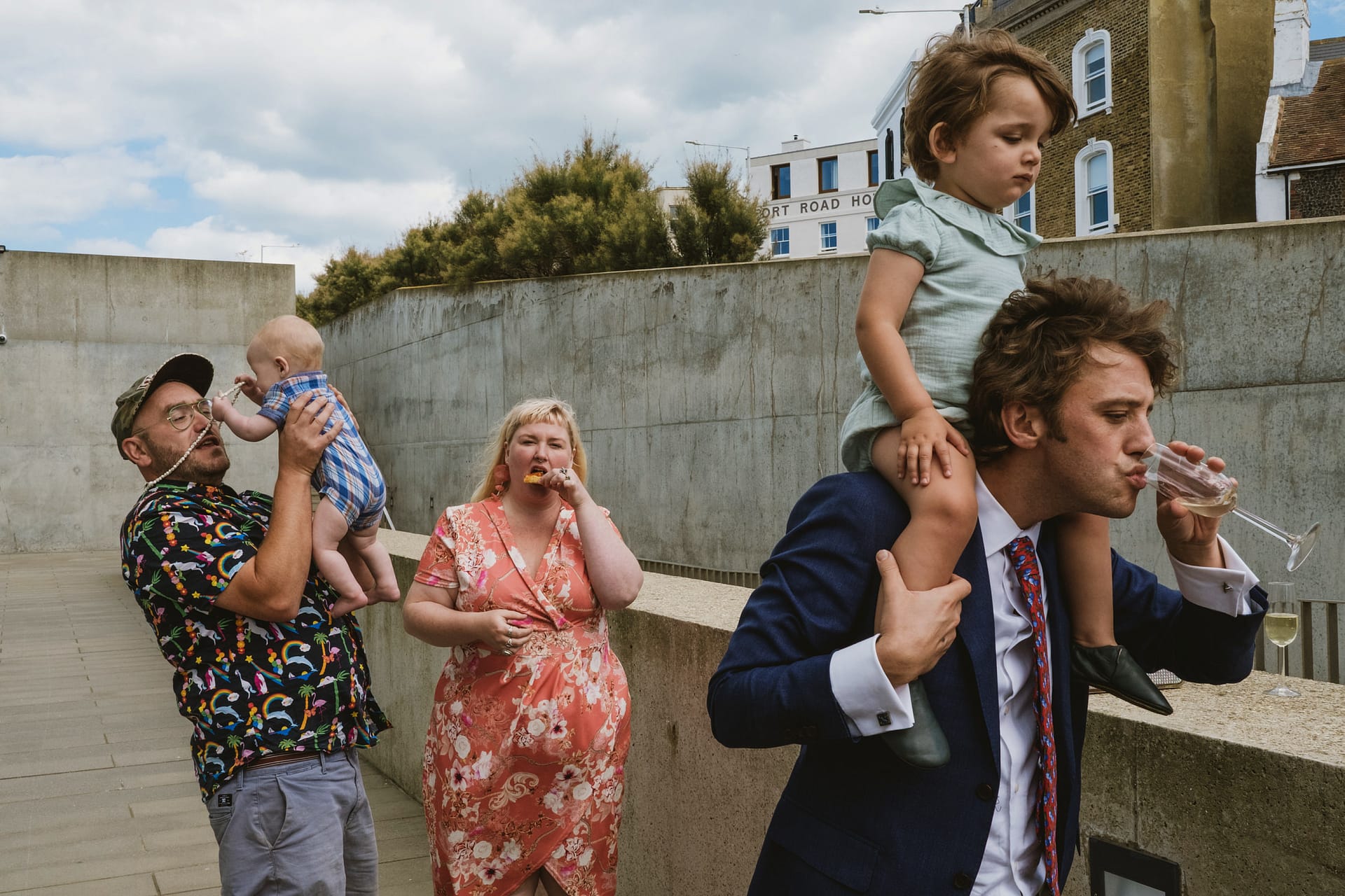 Candid wedding photography by York Place - contrasting styles of parenting are depicted during a wedding reception