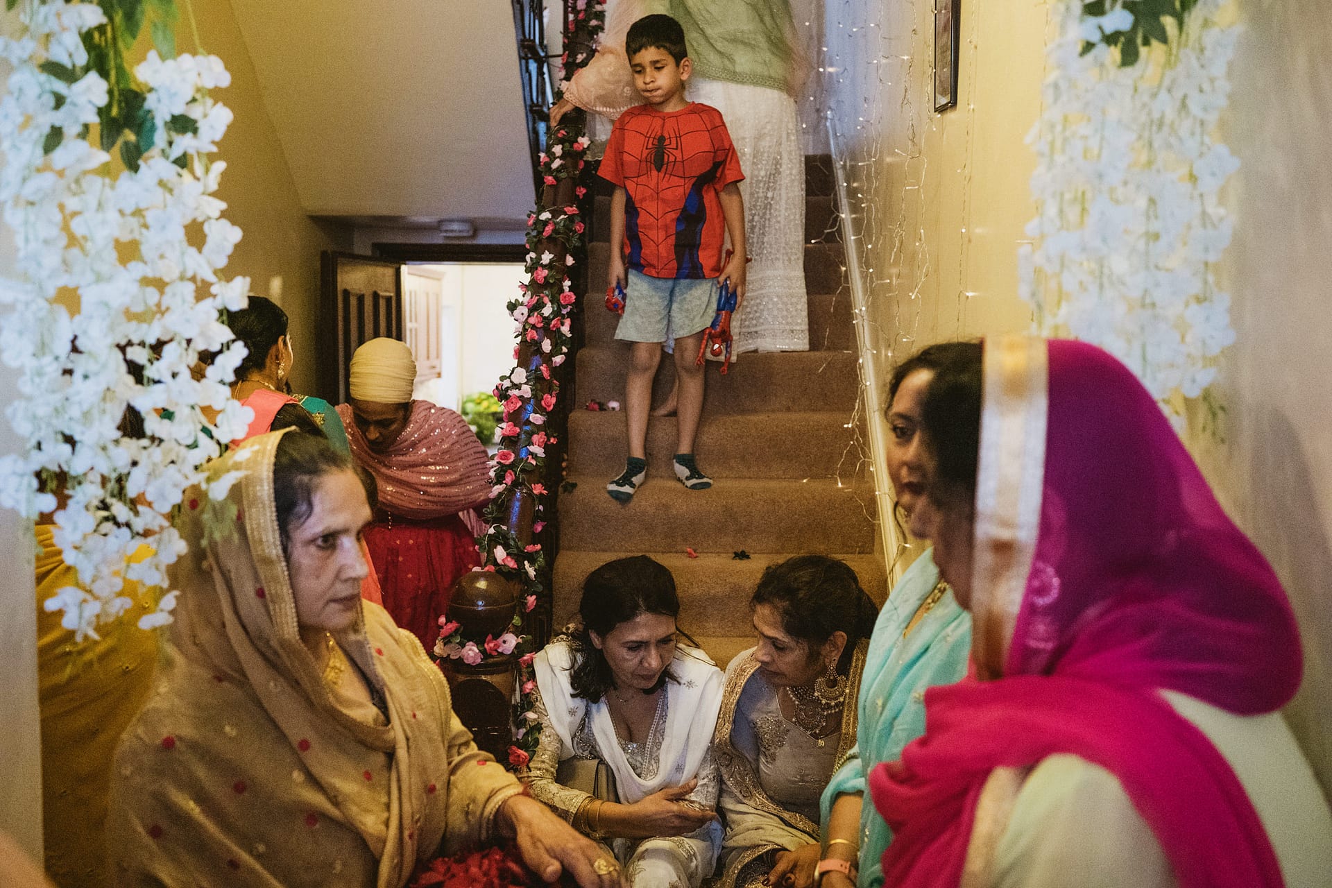 Family gathering with children and adults indoors.