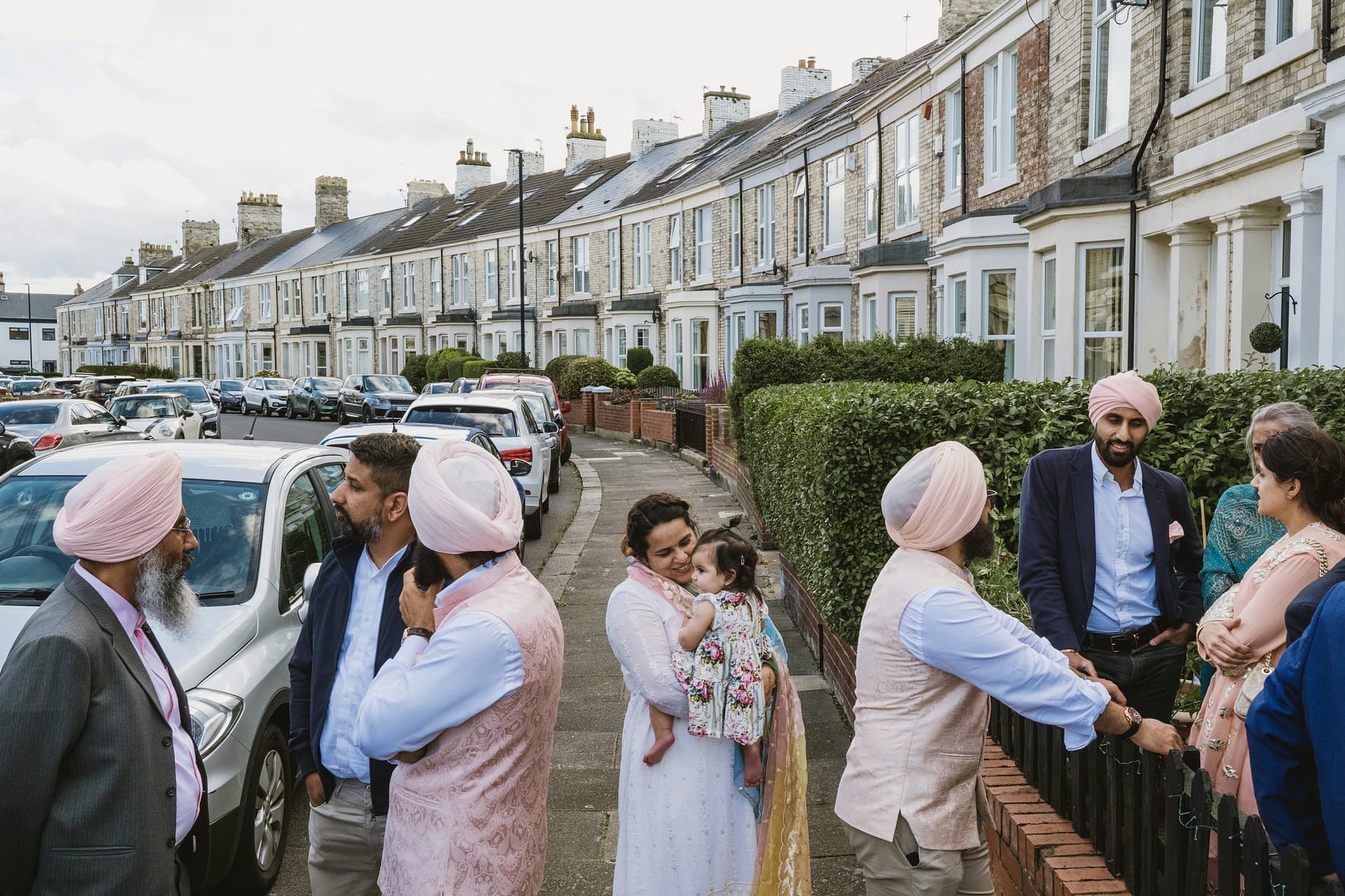 Group of people socialising outside residential buildings.