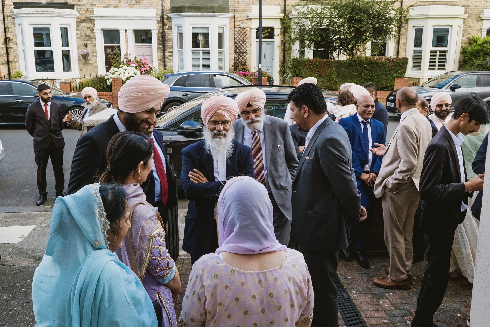 Group of people socialising outside a house.