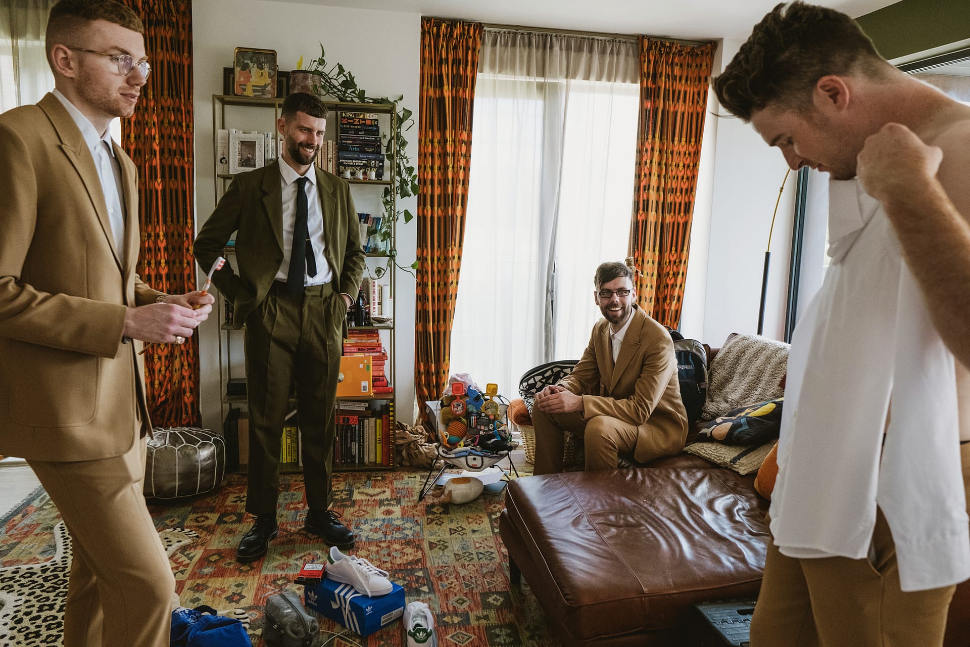 Four men in suits preparing for an event.