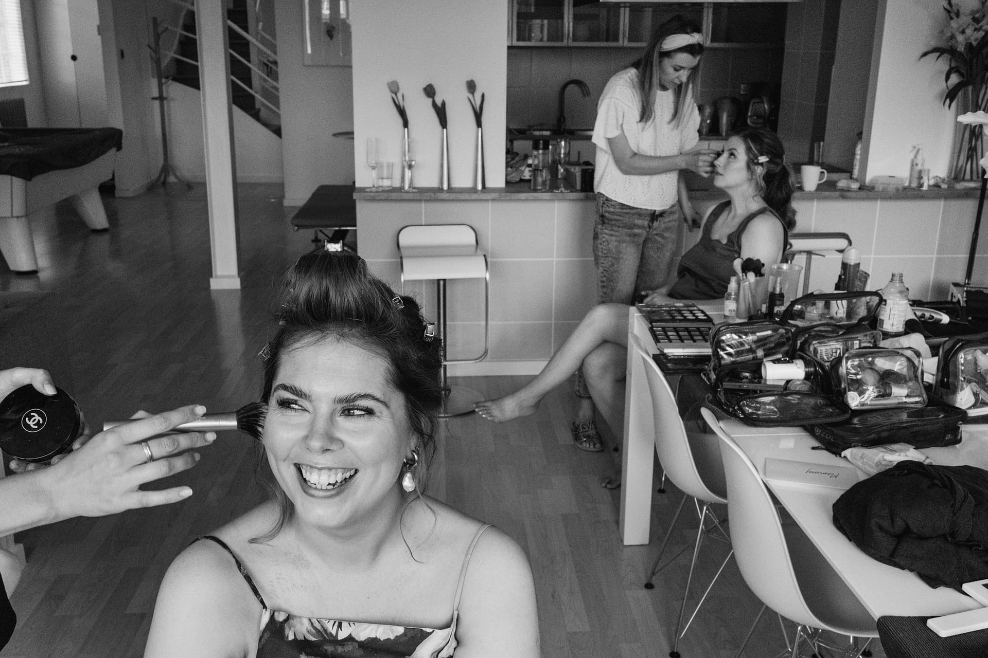 Women getting ready for event with makeup artists.