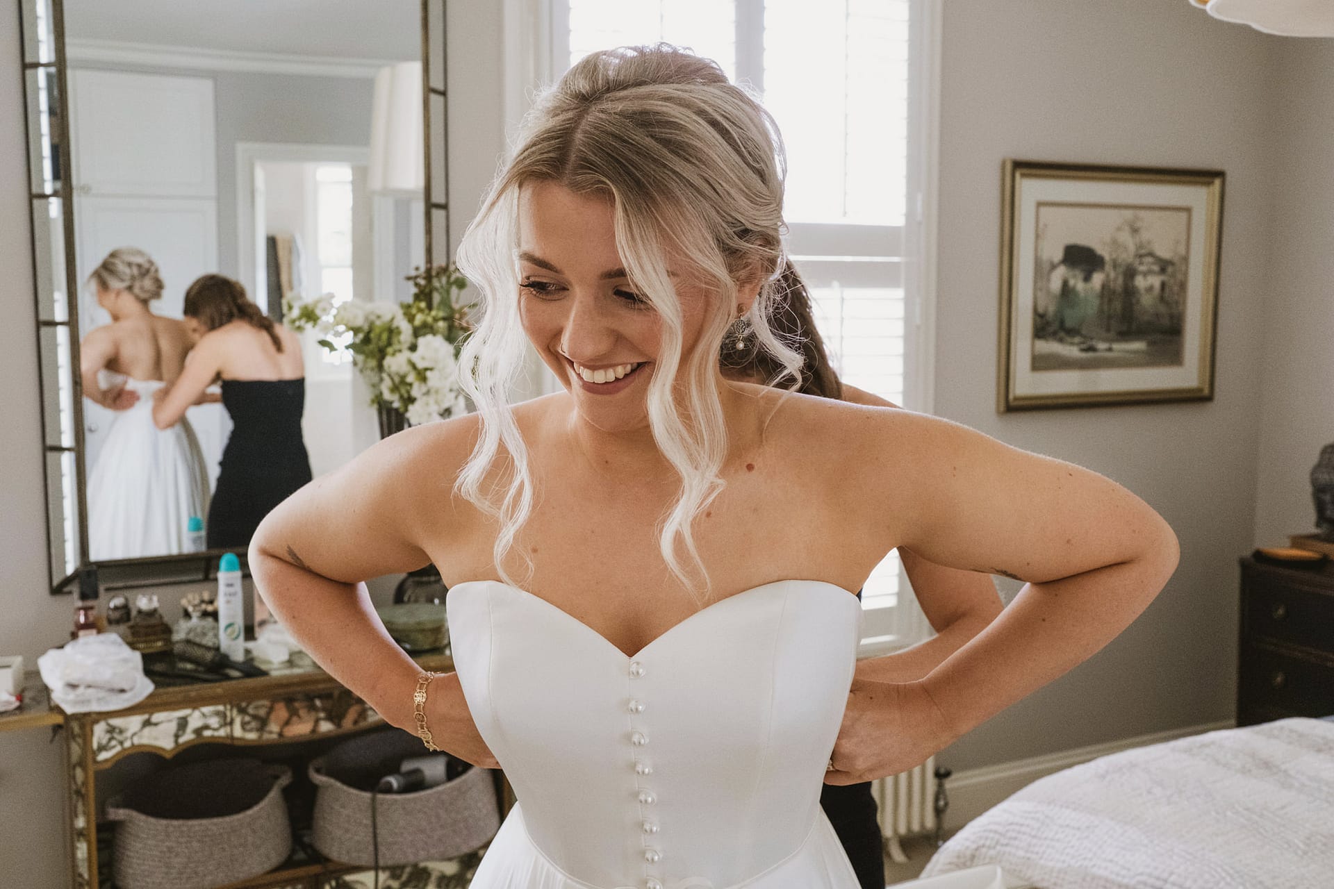 Bride getting ready in white wedding dress