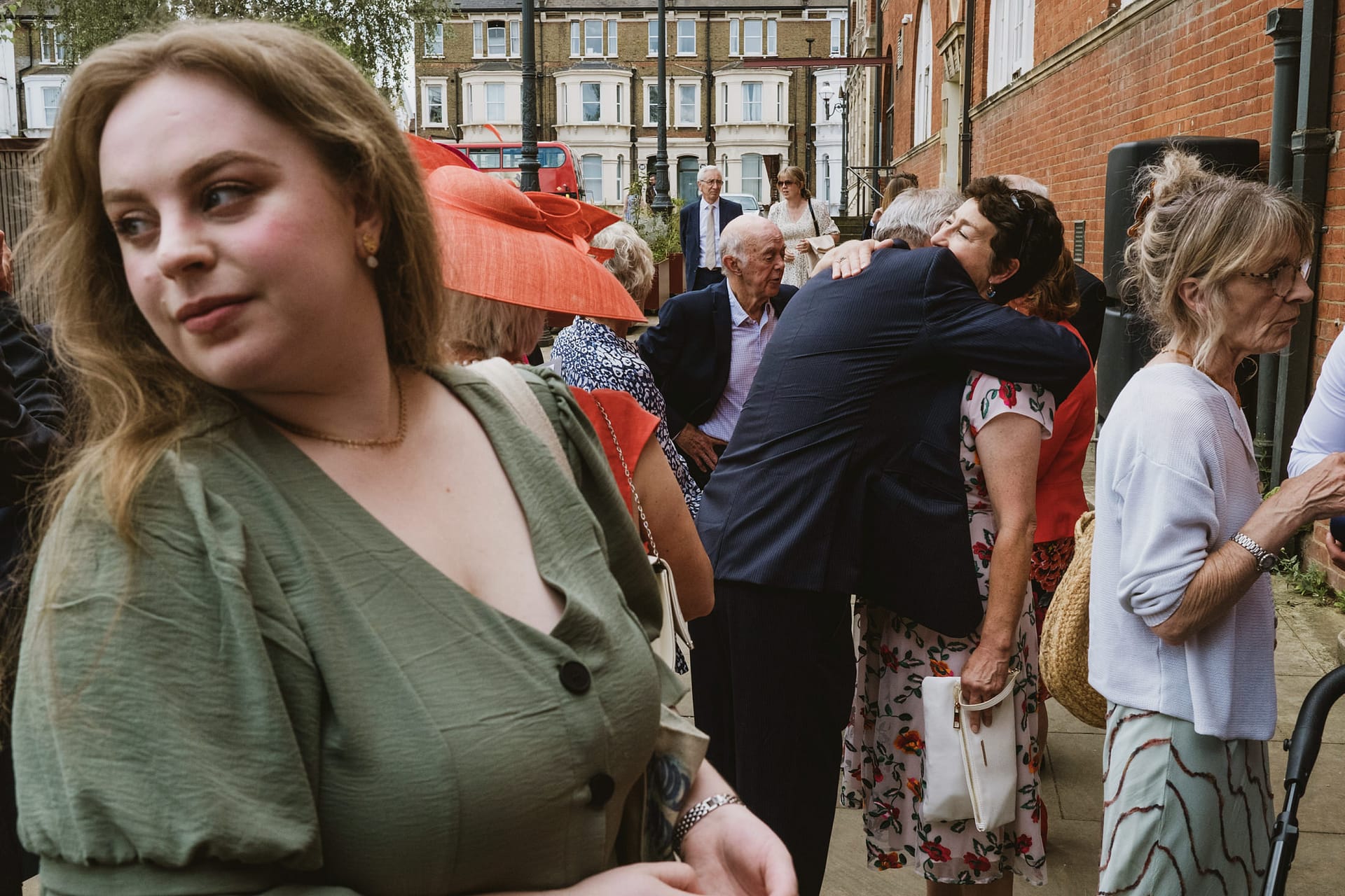 People socialising outside at daytime gathering in city.