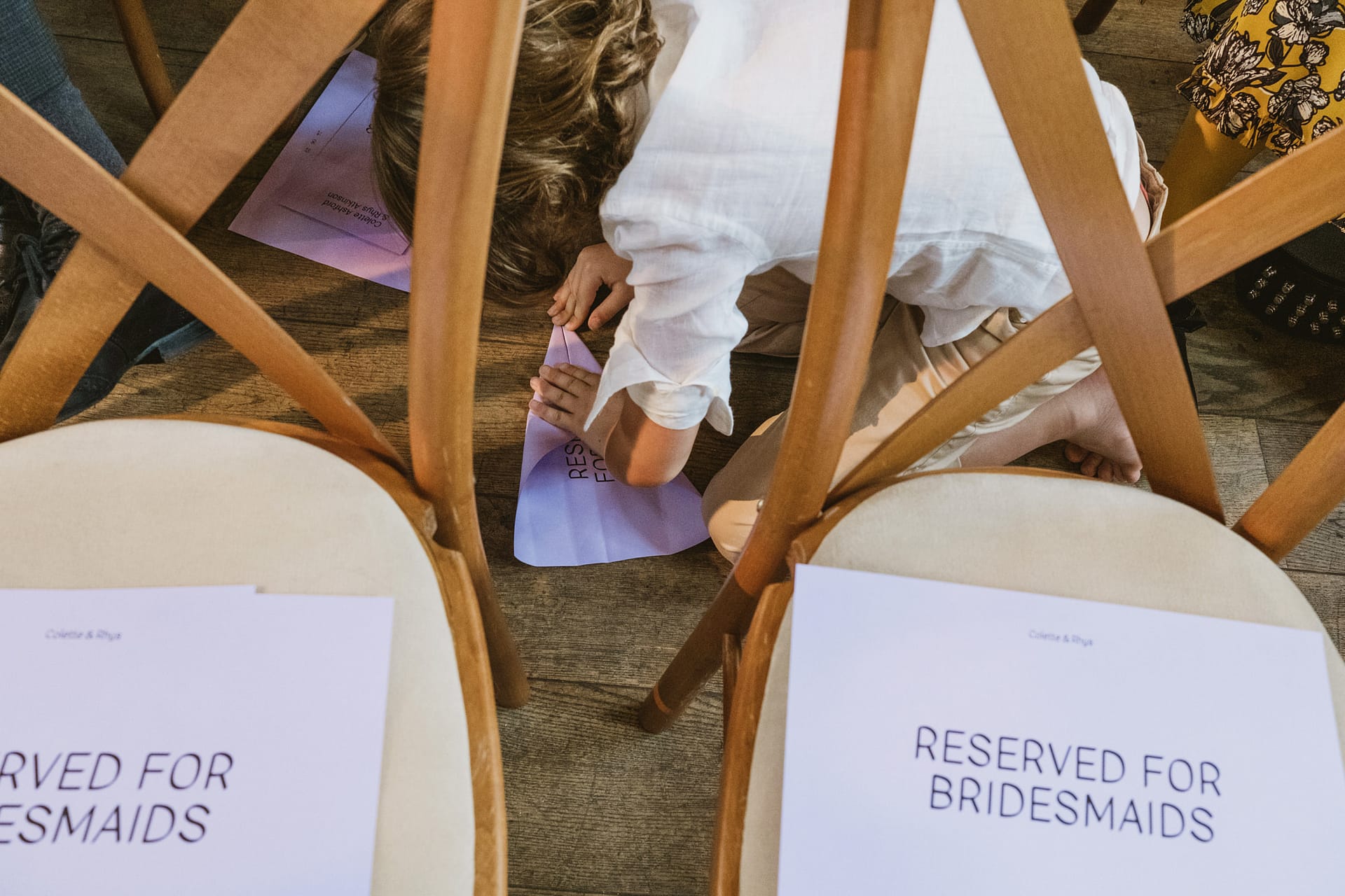 Child arranging reserved seats at wedding ceremony