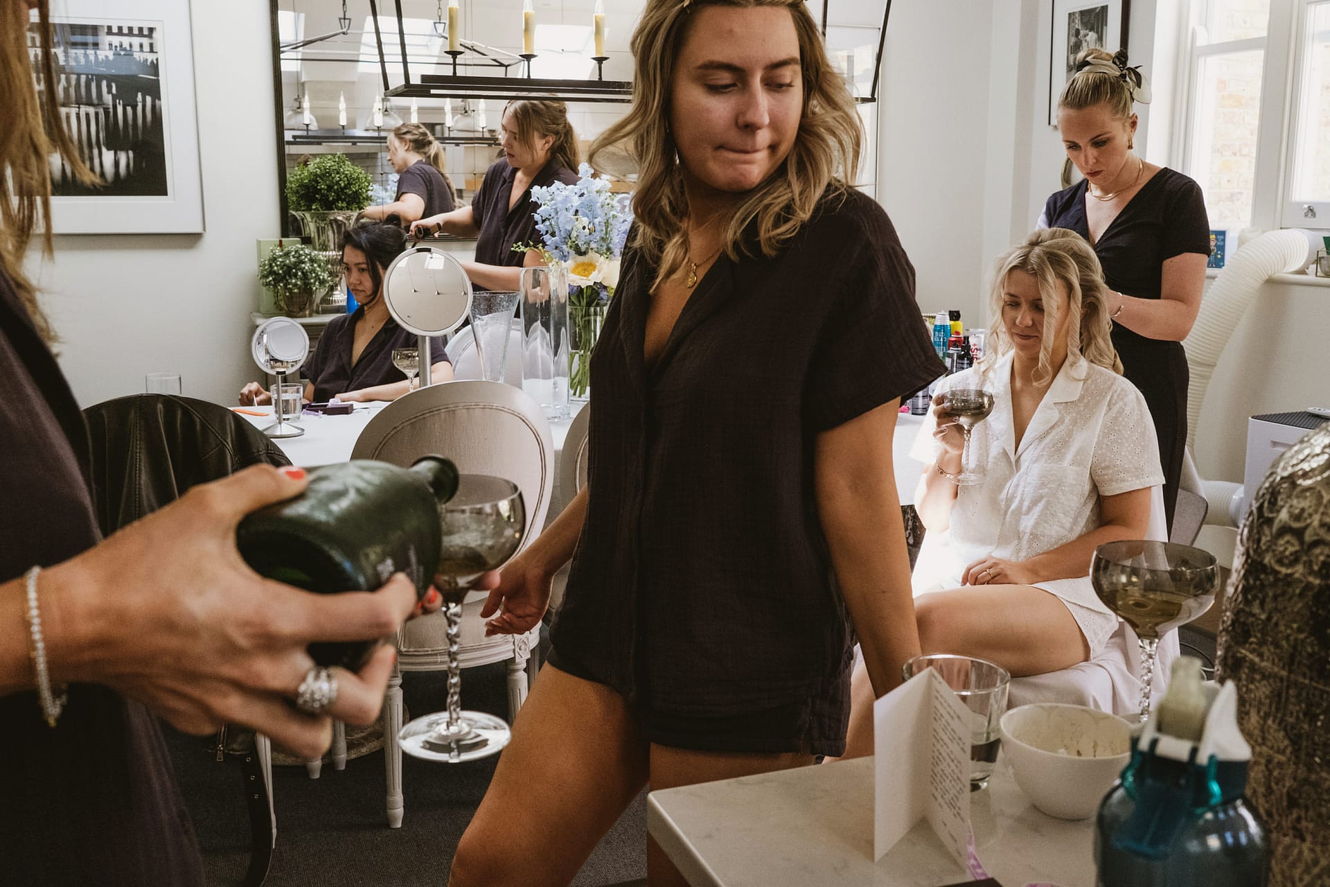 Women preparing for event in stylish room.