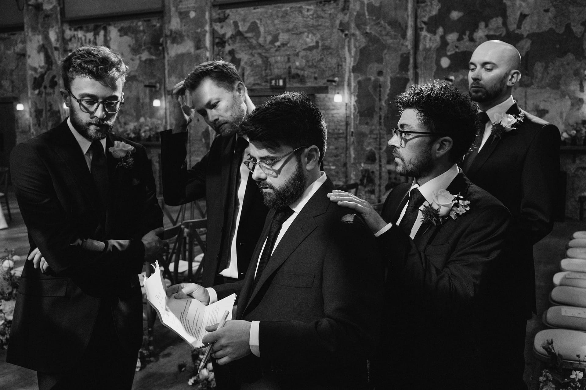 Groomsmen gathered around with wedding speech