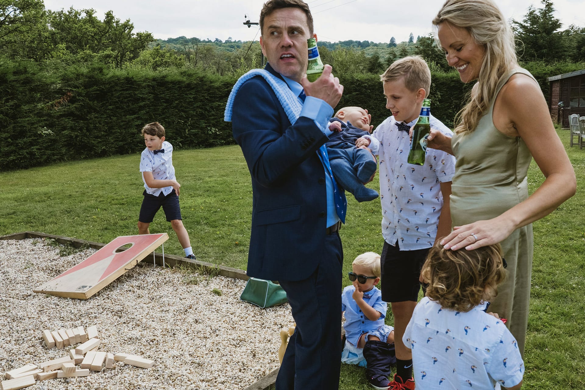 Family and friends in garden playing outdoor games.