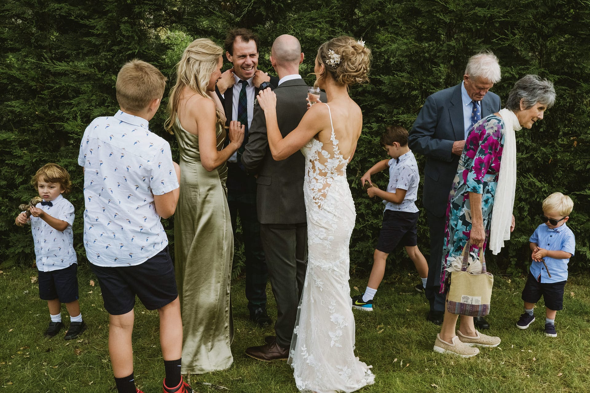 Group of people at outdoor wedding gathering.