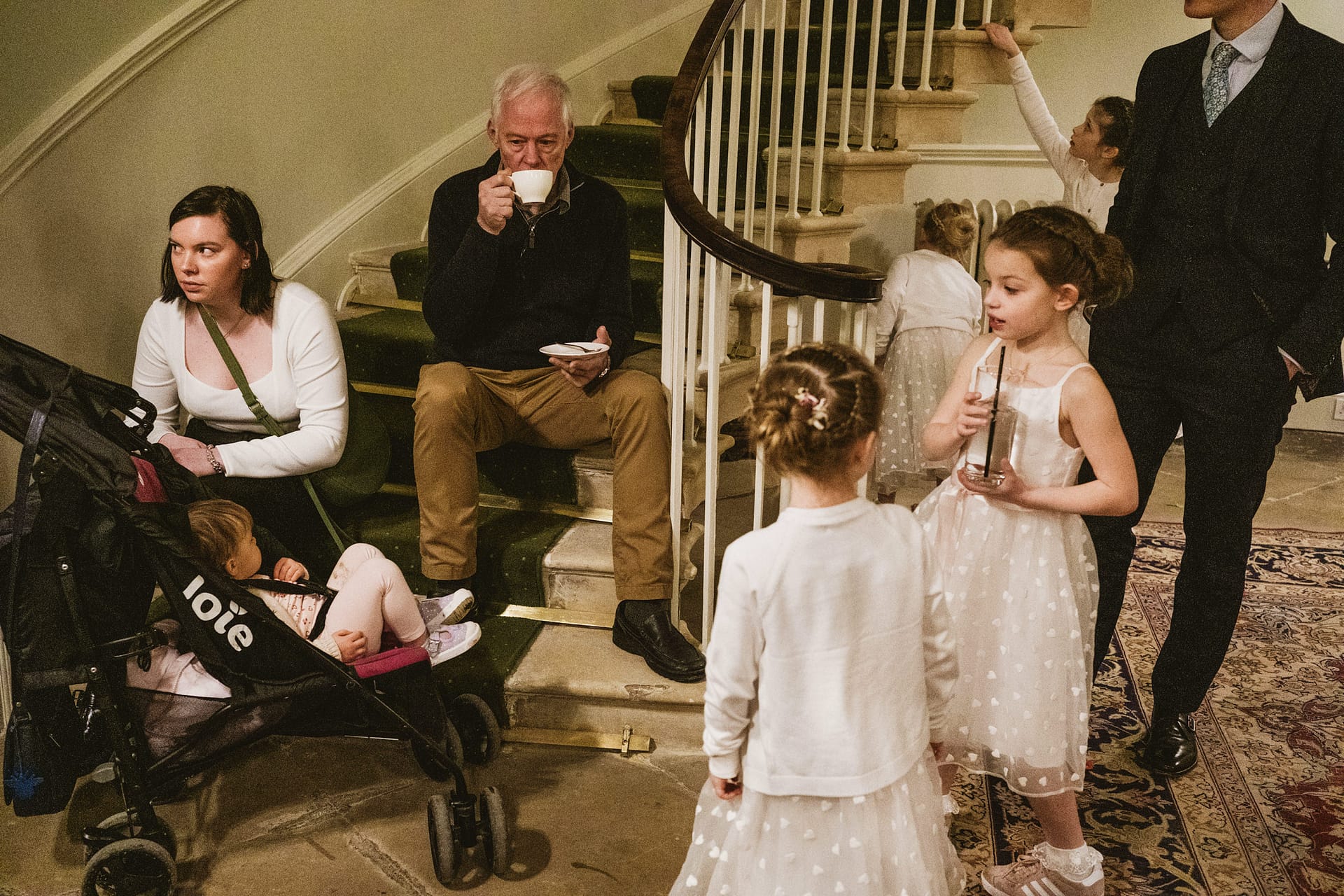 People gathered on staircase at family event.