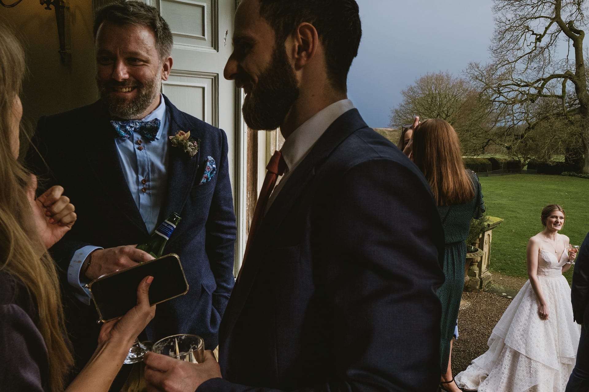 Guests mingling outdoors at a wedding event.