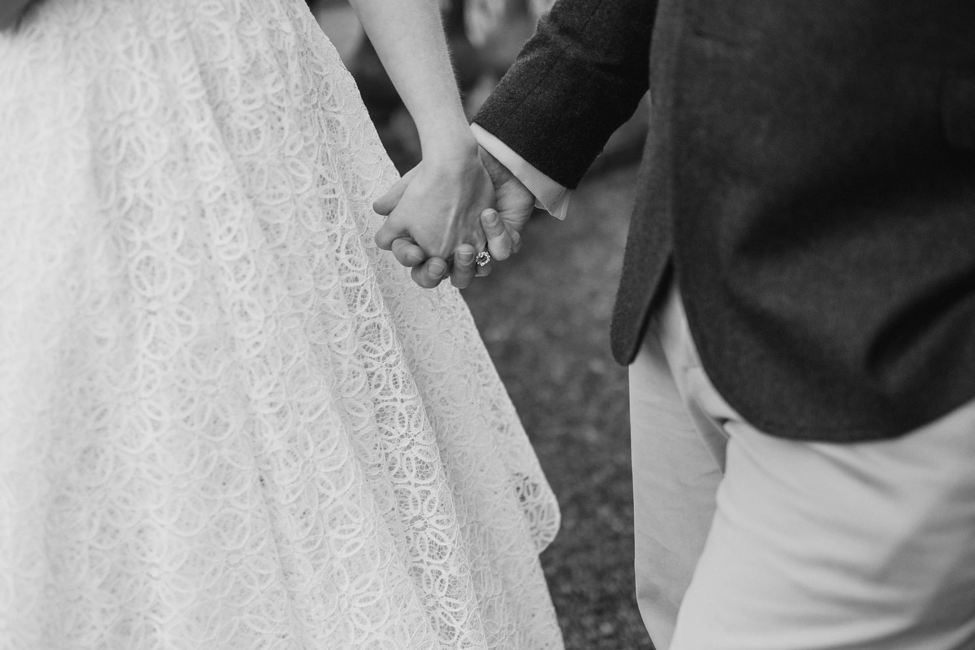 Couple holding hands on wedding day