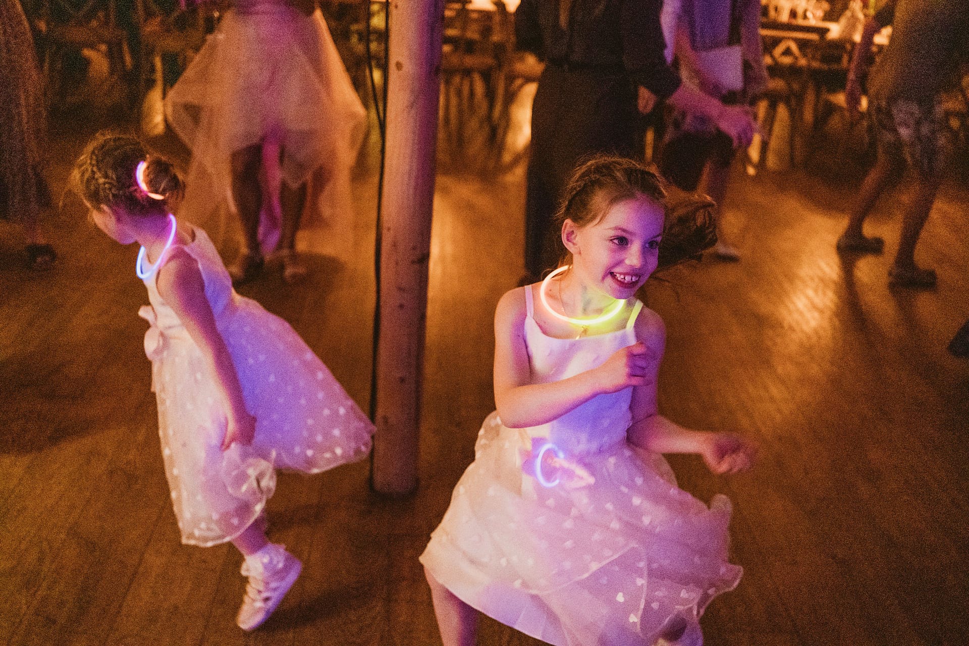 Children dancing with glow sticks at a party.