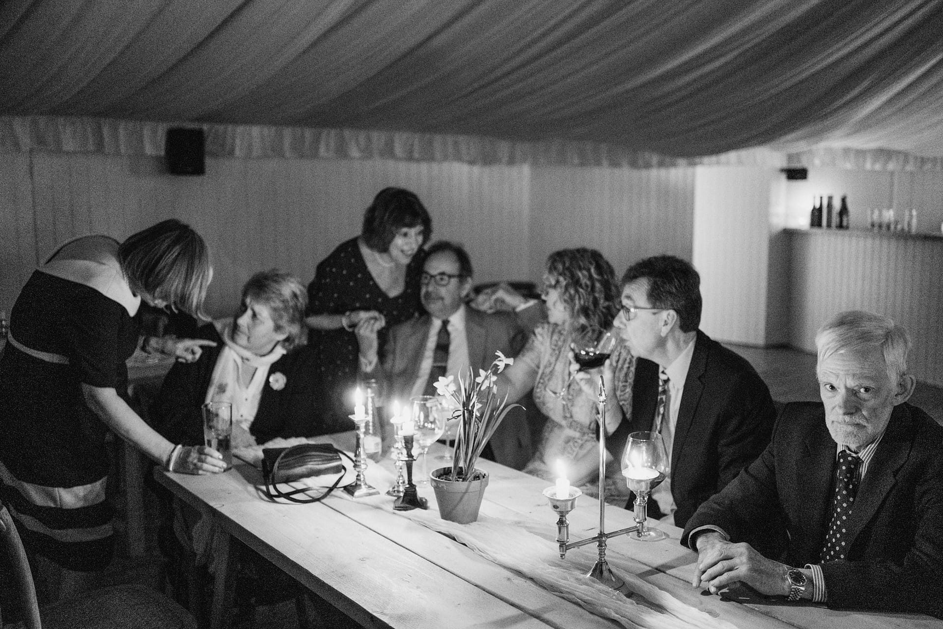 Group at a candlelit dinner gathering.