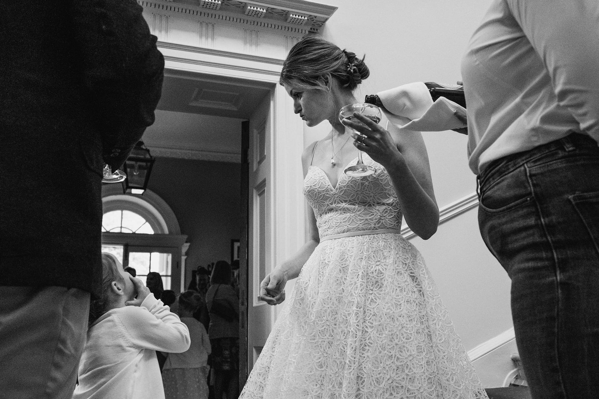 Bride in lace dress holding a glass