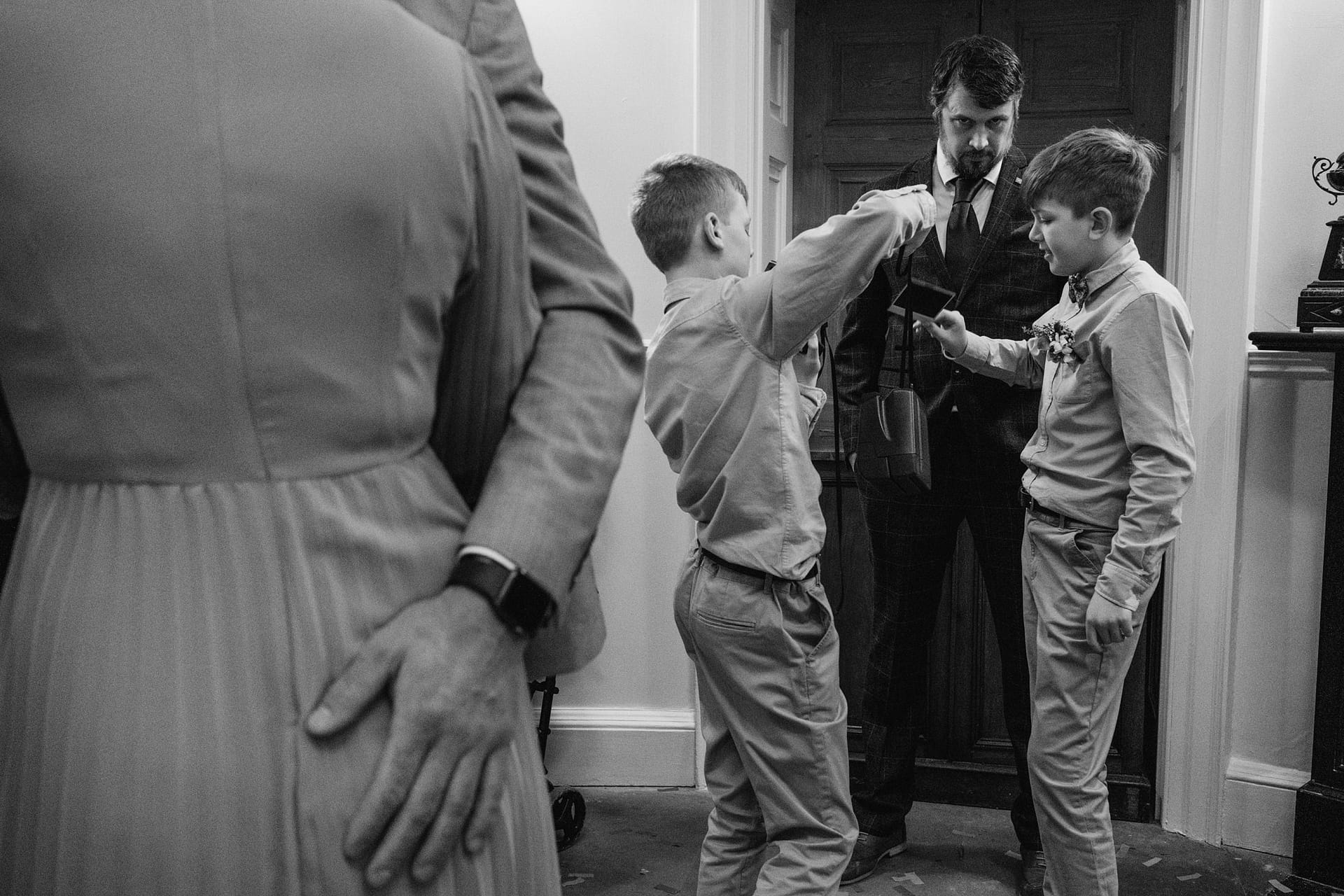 Boys playing in formal attire indoors.