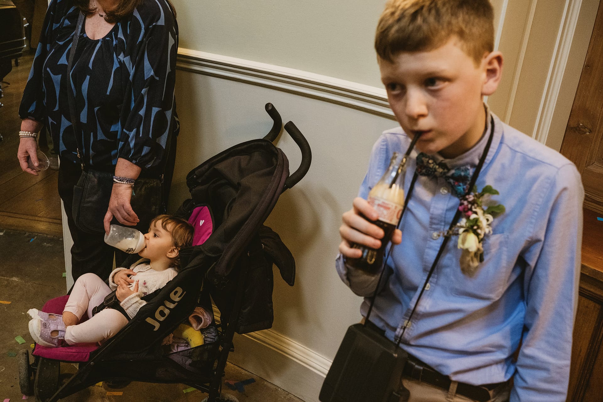 Child drinking bottle, boy sipping soda with straw.