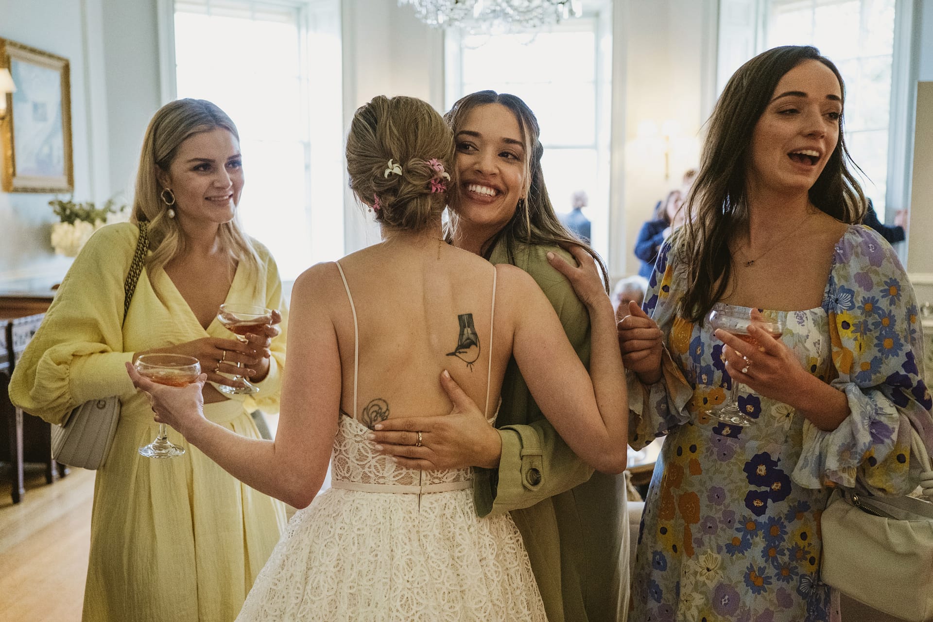 Women celebrating at a joyful wedding gathering.