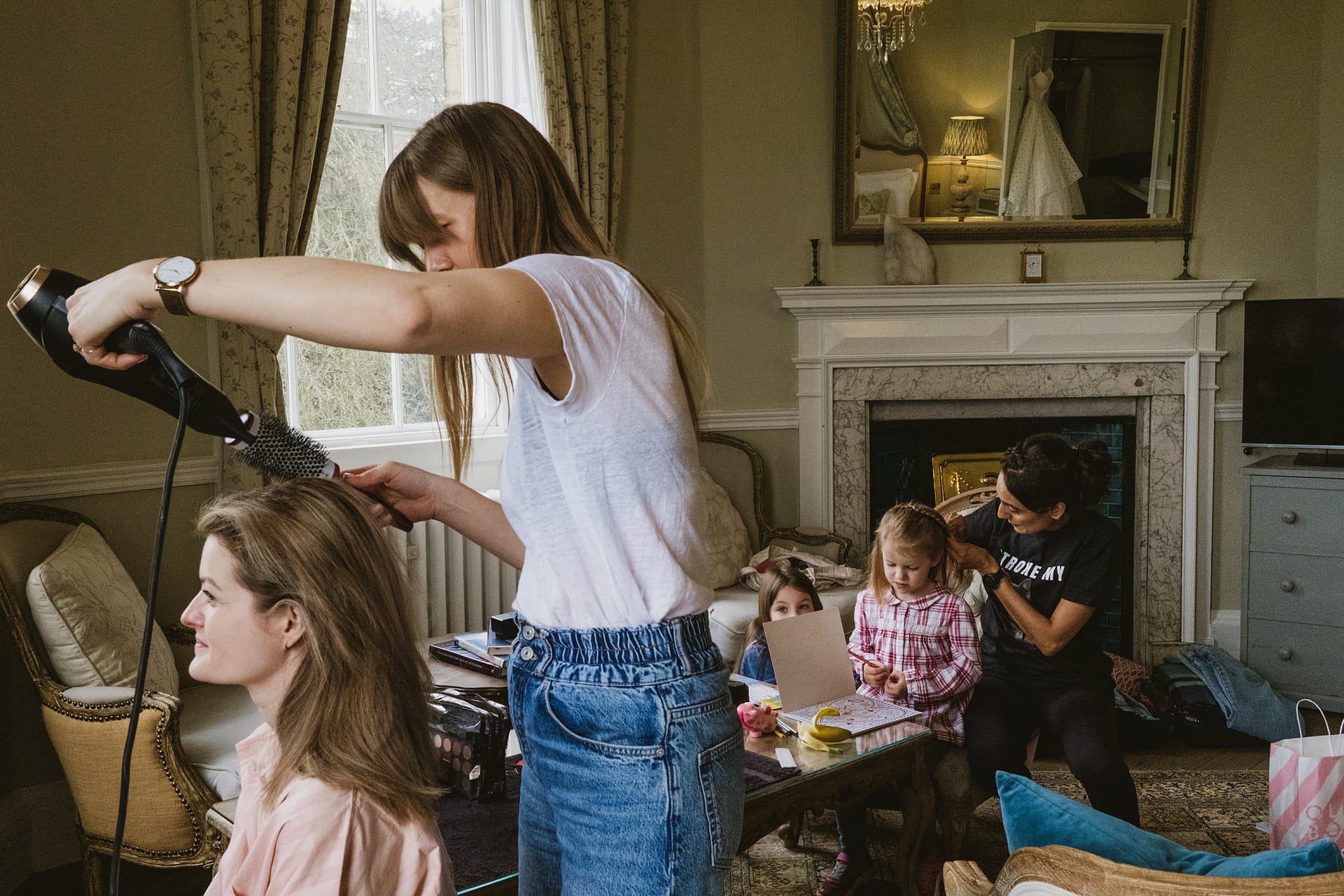 Women styling hair in a cosy family room.