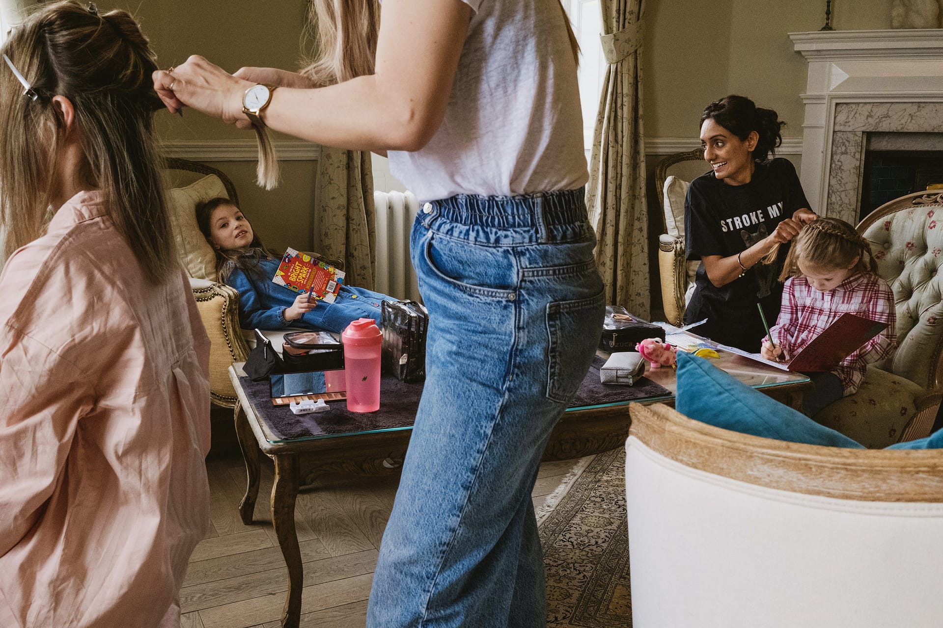 Women and children preparing for an event at home.